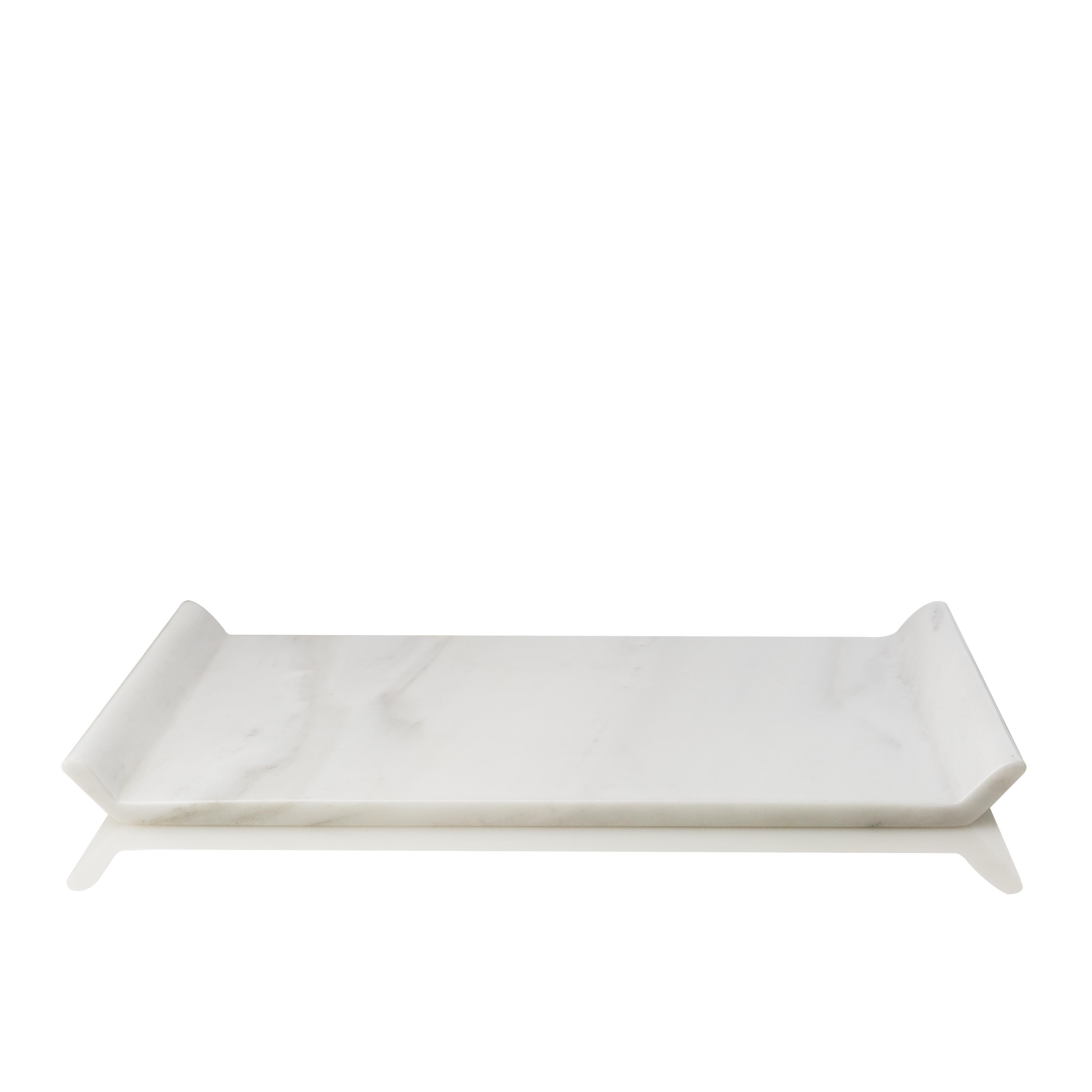 This platter is designed as a homogeneous volume, wishing to engage the senses around the plasticity of marble. It is carved off a single piece of marble without joints or seams.

Io platter has a fine mat finish, revealing the unique color and