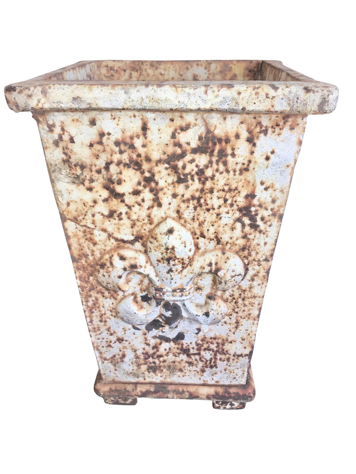 Charming 19th century French iron planter on a plinth base over four feet with worn white paint and a raised fleur-de-lis on two sides.
   