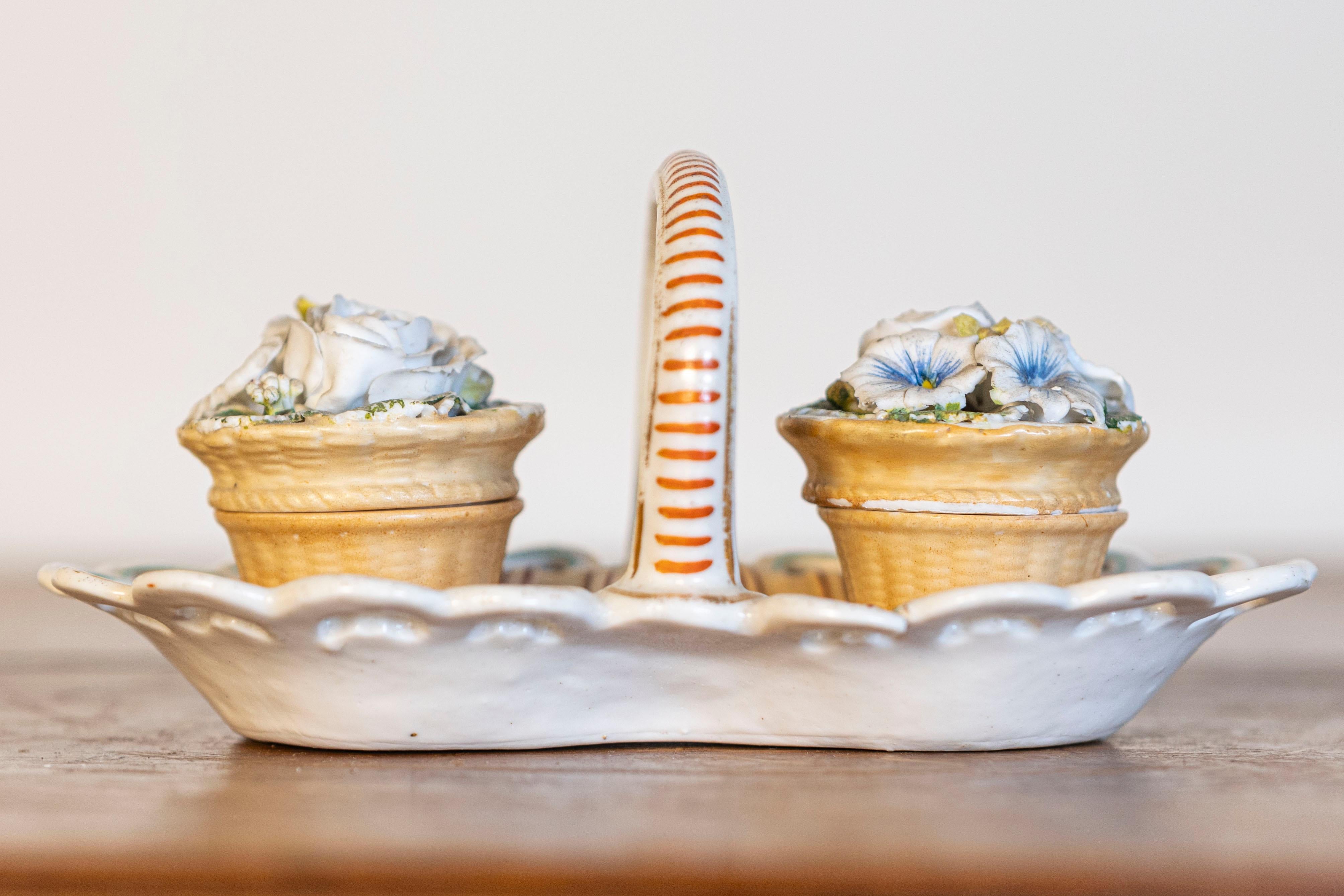 A petite Italian painted ceramic desk set from the mid-19th century, with two floral containers for ink and sand. Born in Italy during the second half of the 19th century, this lovely desk set features a ceramic basket with pierced edges and large