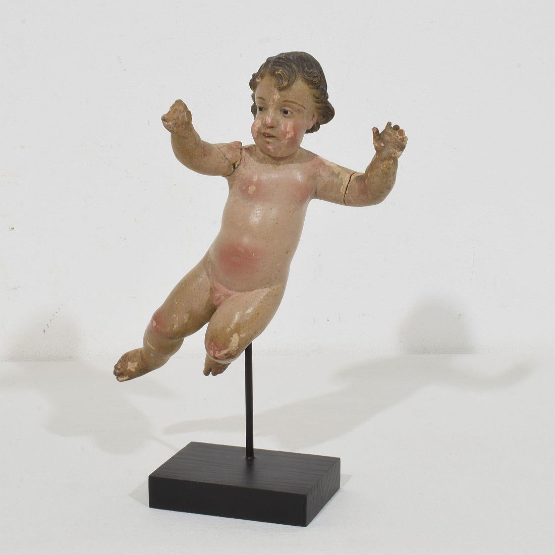 Beautiful small Baroque angel with glass eyes. Unique period piece made out of wood . Hand-carved 
Italy, circa 1700- 1750
Weathered, small losses and old repairs

Measurement here below includes the wooden base.
H:23,5cm  W:16cm D:8cm 