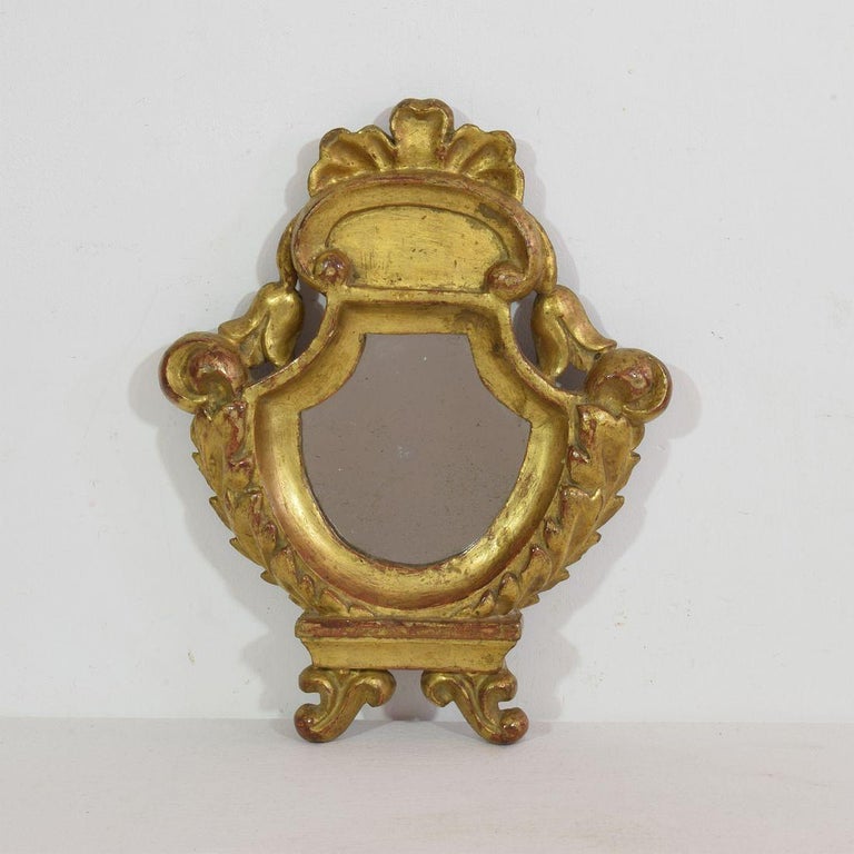 Very nice small giltwood neoclassical mirror, with original mirror glass, Italy, circa 1780. Weathered, small losses and old repairs.