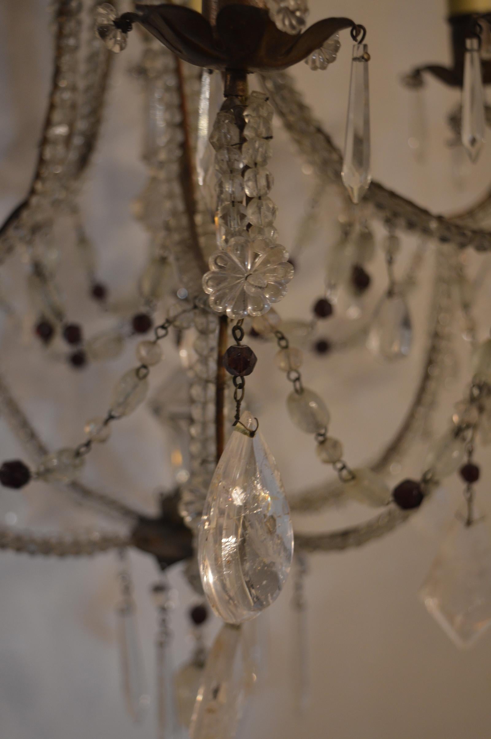Crystal beaded chandelier adorned in rock crystal and crystal hanging pieces.
