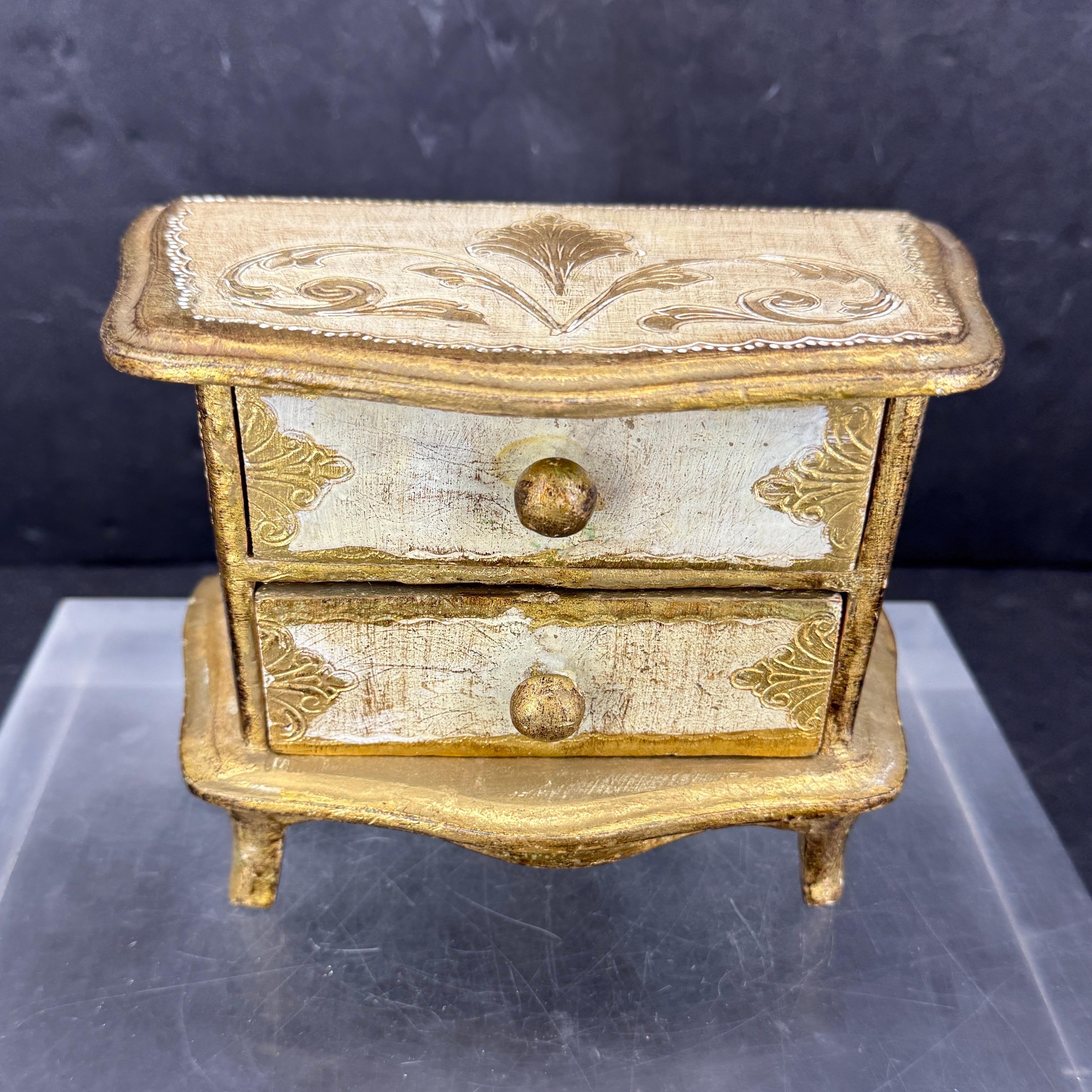 This vintage gilt wood storage or jewelry box features two drawers. The box has lots of character, charm and patina. Wonderful piece to add to a collection or start a new one with these highly sought after pieces. 
Marked 