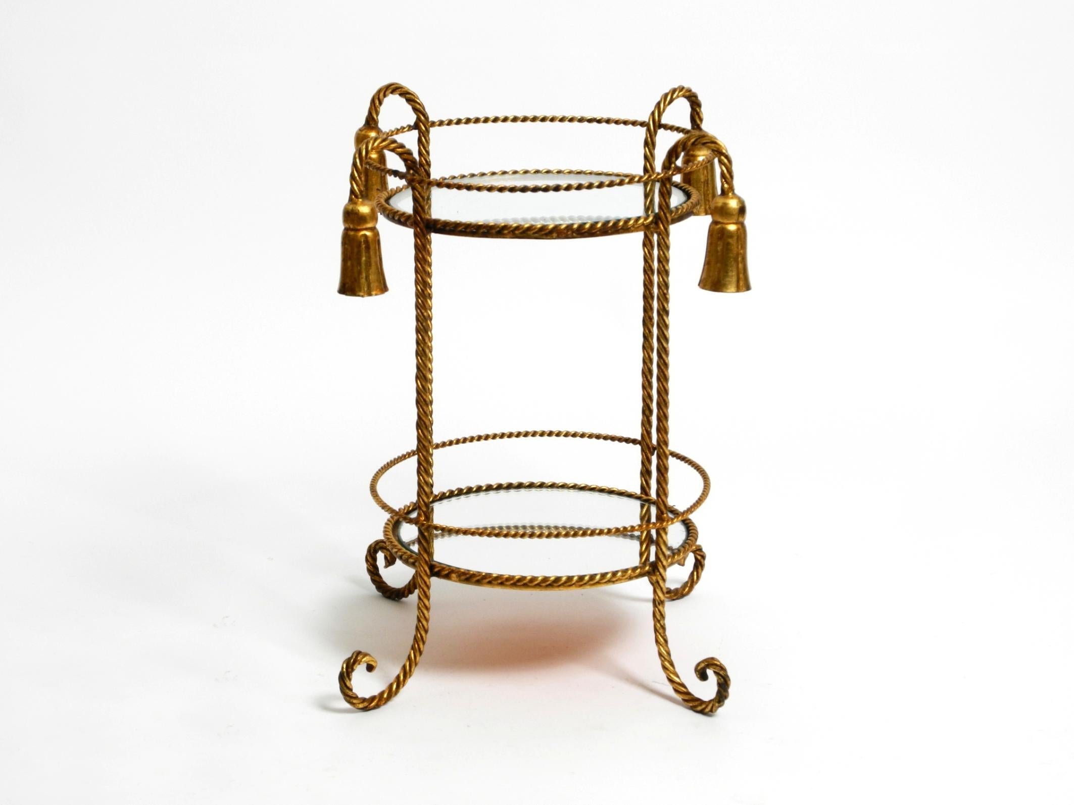 Very elegant, small Mid-Century Regency side table made of gold-plated iron.
Manufacturer is Li Puma Firenze. Made in Italy.
Made of twisted gold-plated iron.
Very high-quality, fine craftsmanship.
Beautiful 1960s design with many details.
The upper
