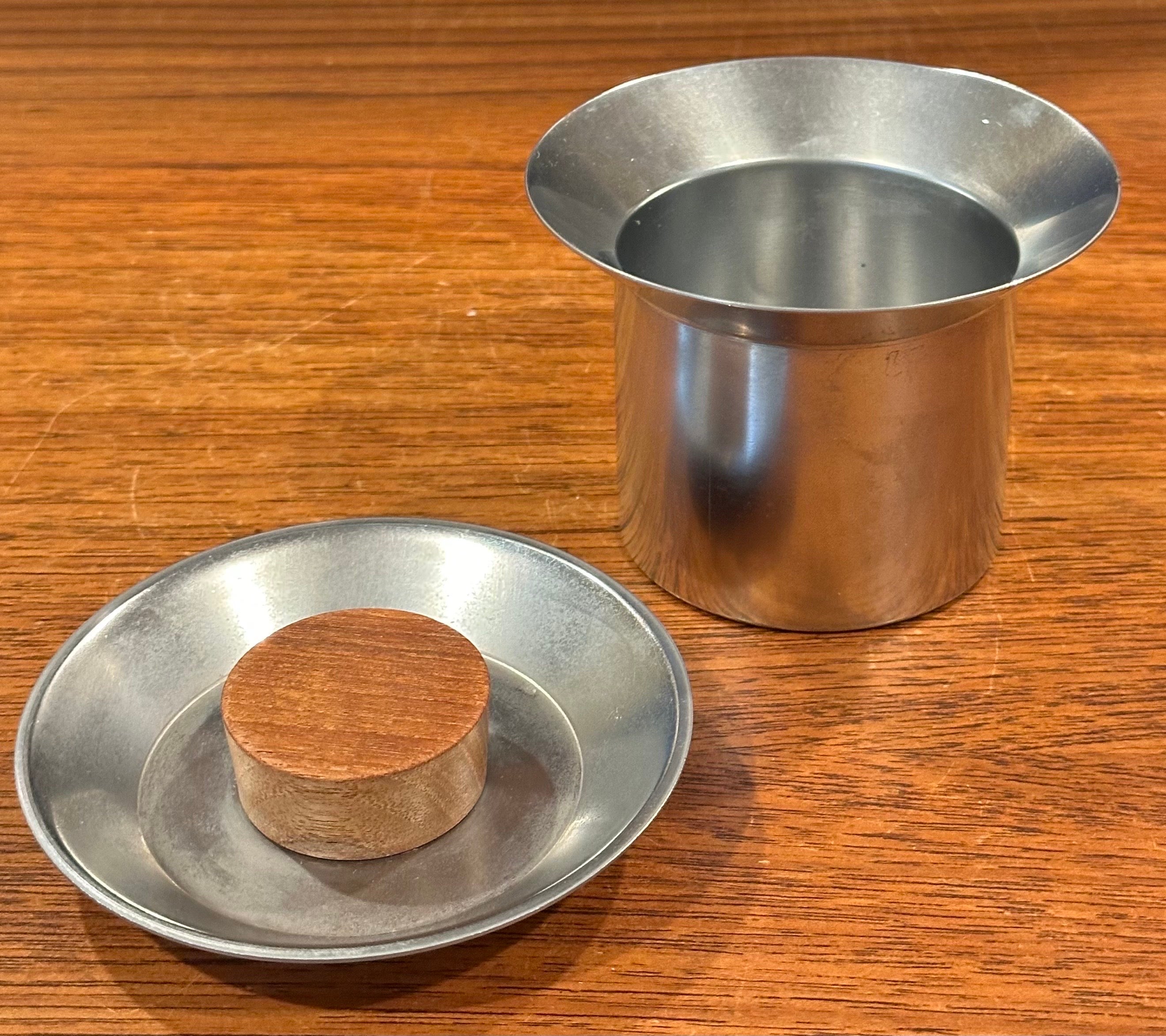 Small Italian modernist stainless steel trinket box with teak knob, circa 1970s.  The piece is in very good vintage condition and measures 4