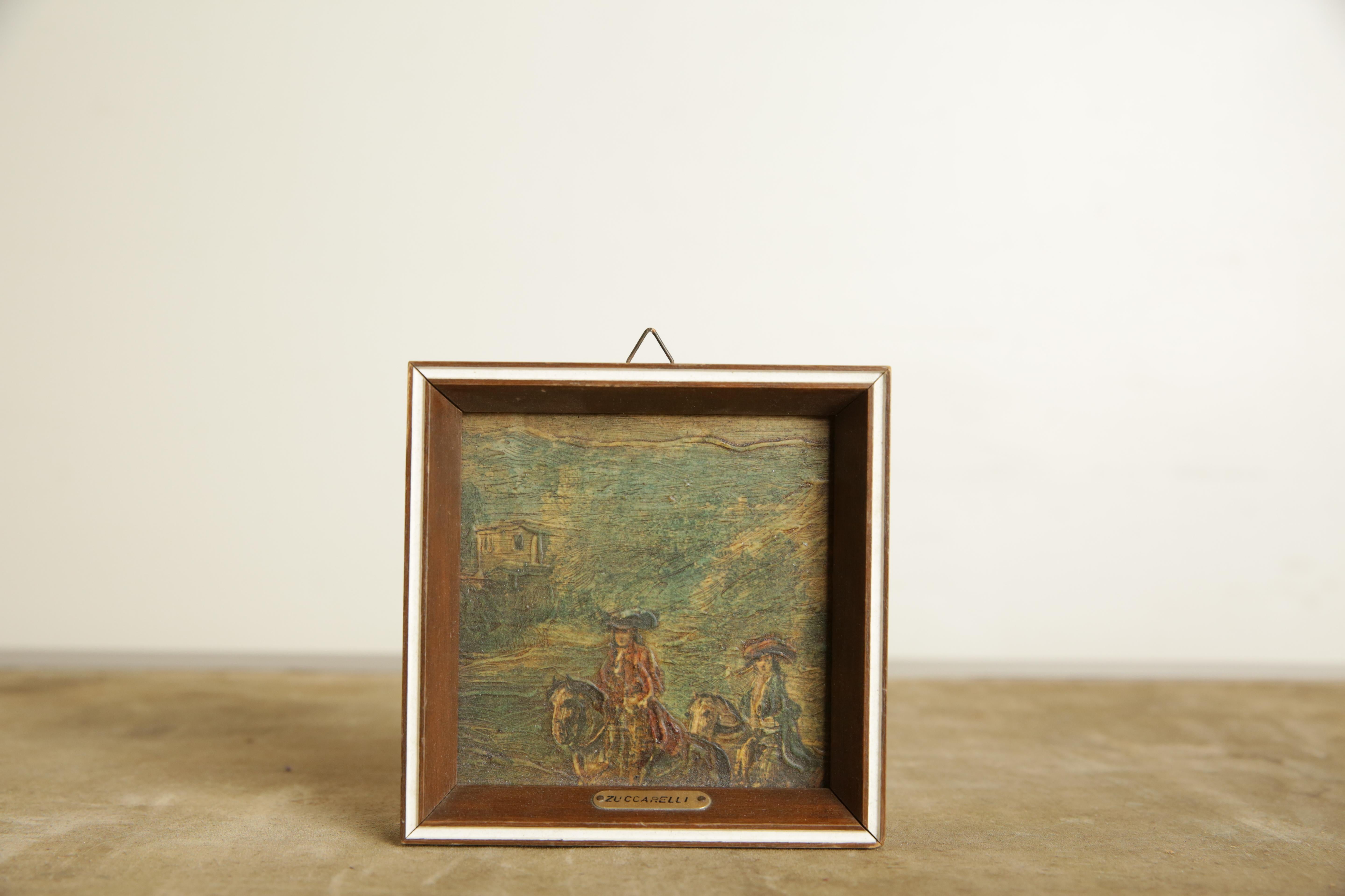 In a small square (later) frame with a small plaque attributing Francesco Zuccarelli of Tuscany, b. 1702 d. 1788, depicting two riders in a landscape with a villa in the distance