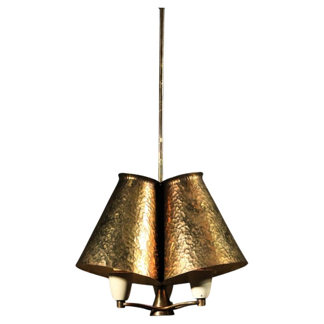 Small Italian pendant light from the 1950s composed of three conical lampshades in brass-plated and hammered zinc on the outside and a hanging system in solid brass tubes. Very beautiful vintage condition, note slight traces of use and time on the