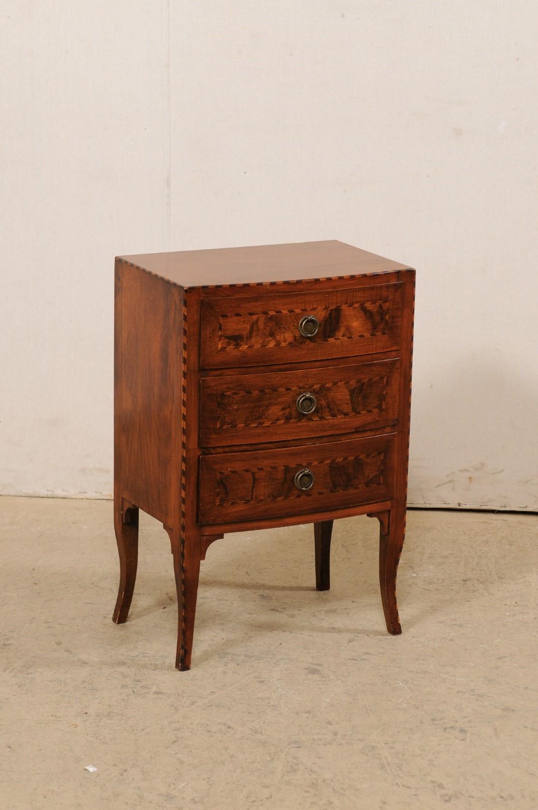 An Italian raised side chest with drawers and decorative inlay from the mid 20th century. This vintage case piece from Italy is adorn with roped inlay banding outlining it's edges, inlayed drawer fronts, and down the curvy lines of it's front legs.