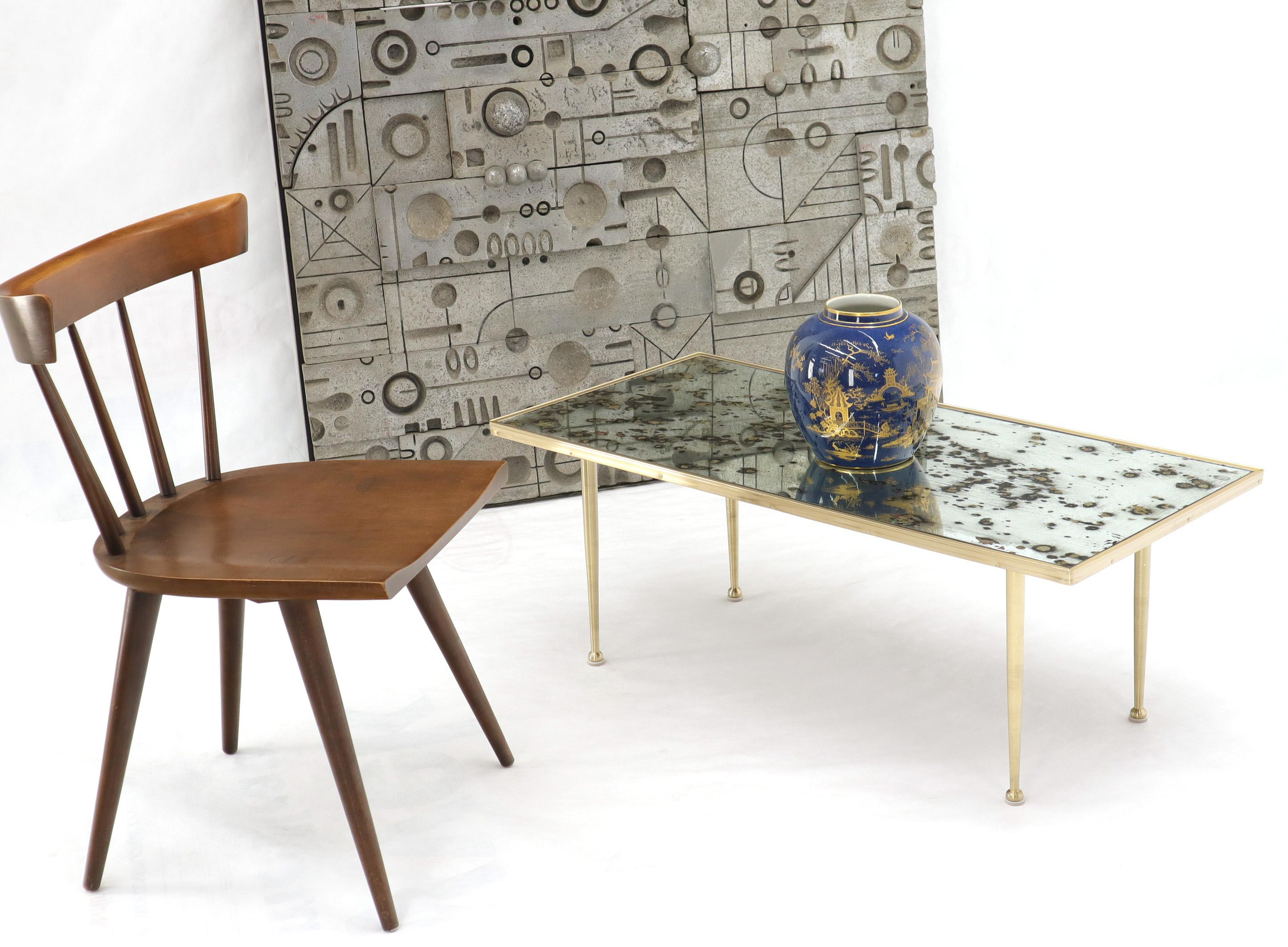 Mid-Century Modern spotted smoked mirror top rectangular Mid-Century Modern coffee table. Gio Ponti style tepered legs with ball shape feet.