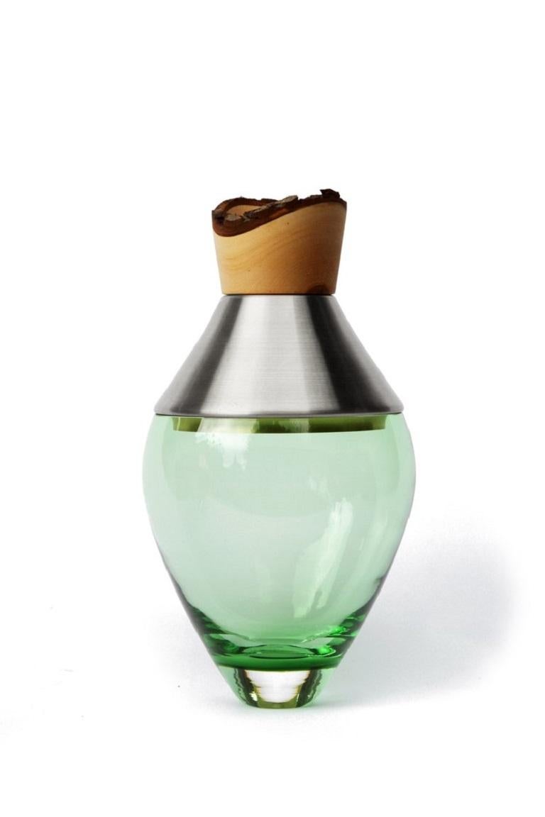 Small Jade India Vessel I, Pia Wüstenberg.
Dimensions: D 15 x H 30.
Materials: glass, wood, metal.
Available in other metals: brass, copper, copper patina, aluminum.

Handmade in Europe, by individual craftsmen: handblown glass (Czech