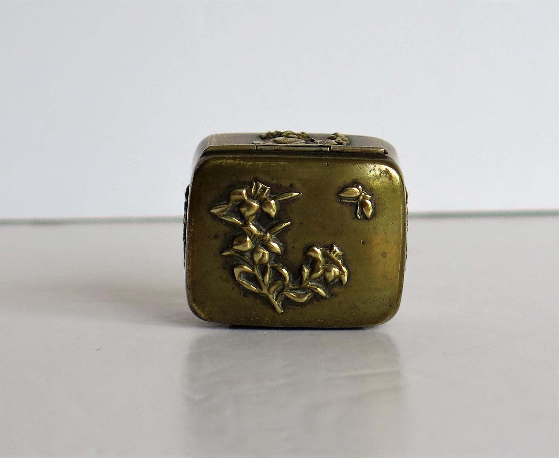 a small bronze box with a