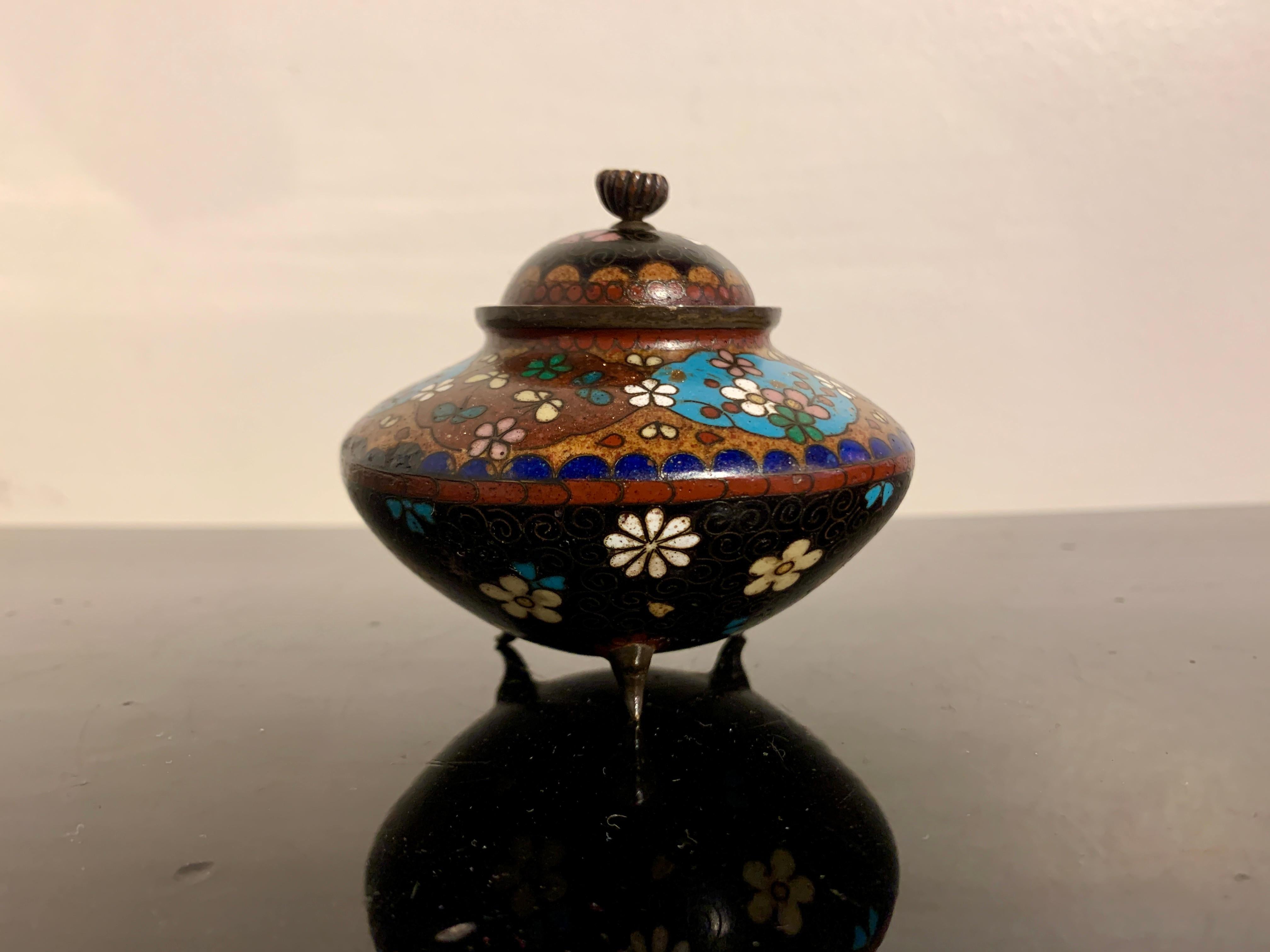 A small and delightful Japanese cloisonné and goldstone tripod incense burner and cover, Meiji period, late 19th century, Japan.

The small incense burner, called a koro, is comprised of a squat, compressed globular body supported by three short