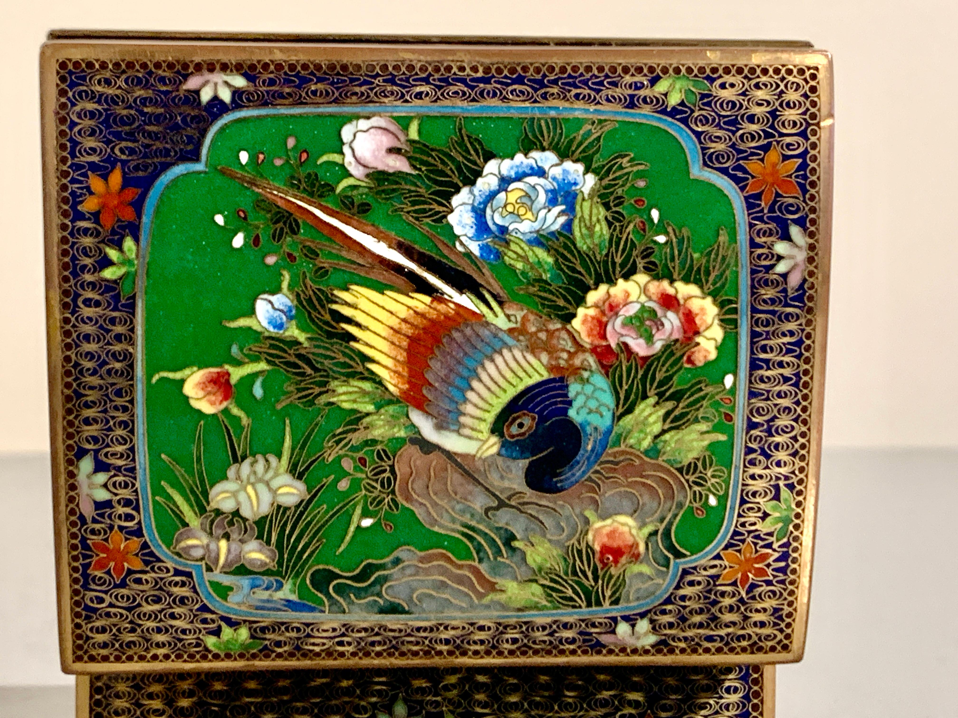 A delightful small Japanese cloisonne enamel trinket box with a pheasant design, Meiji Period, Japan.

The small cloisonne box features a hinged lid of slightly domed shaped. The lid decorated with a central of a large colorful pheasant nestled upon