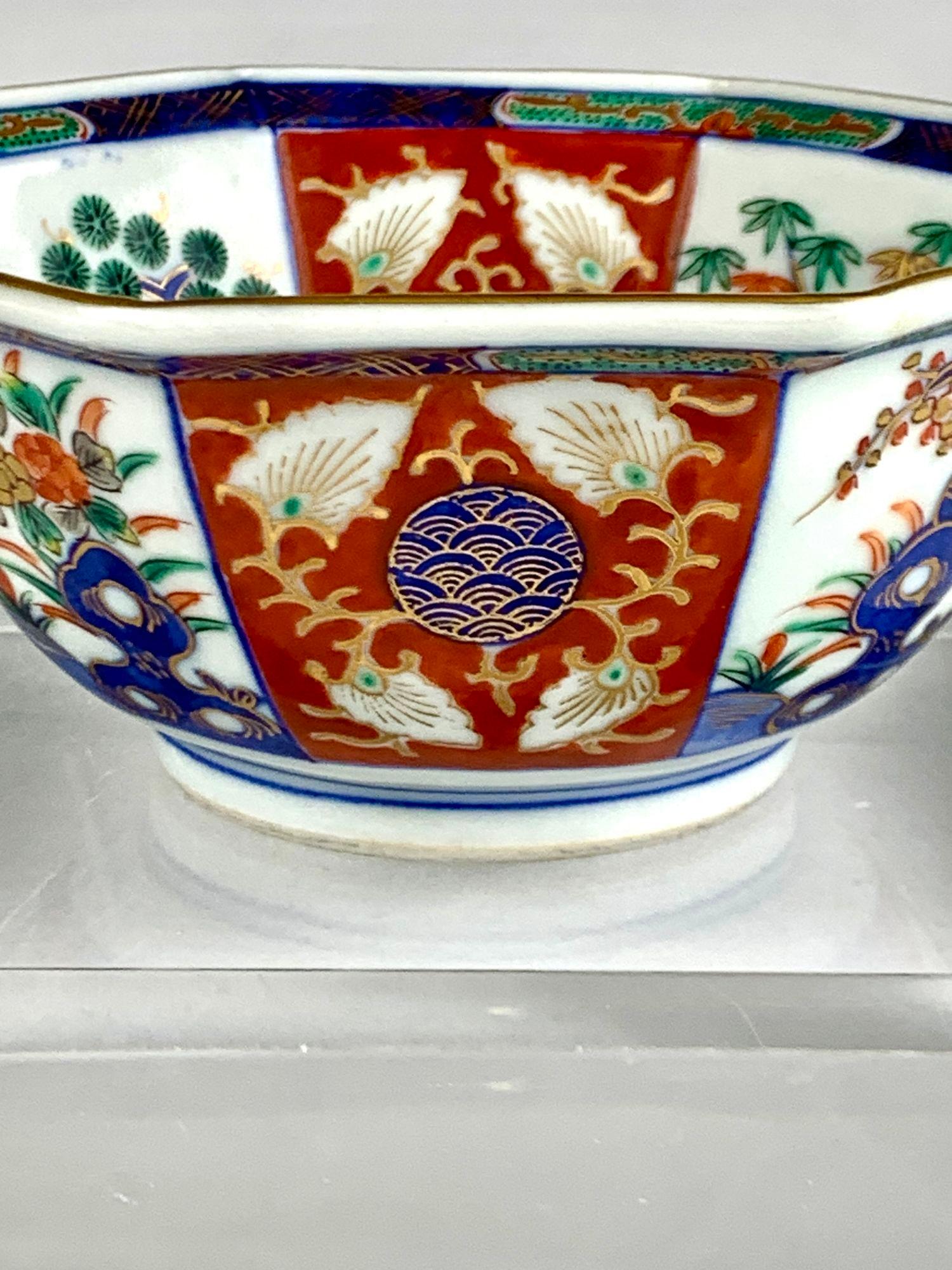 This delicate Japanese bowl was handpainted during the Meiji Period, circa 1880.
The traditional octagonal shape is decorated with eight panels in the Imari style.
We see panels in iron red with a gold and blue wave pattern in the center.
These