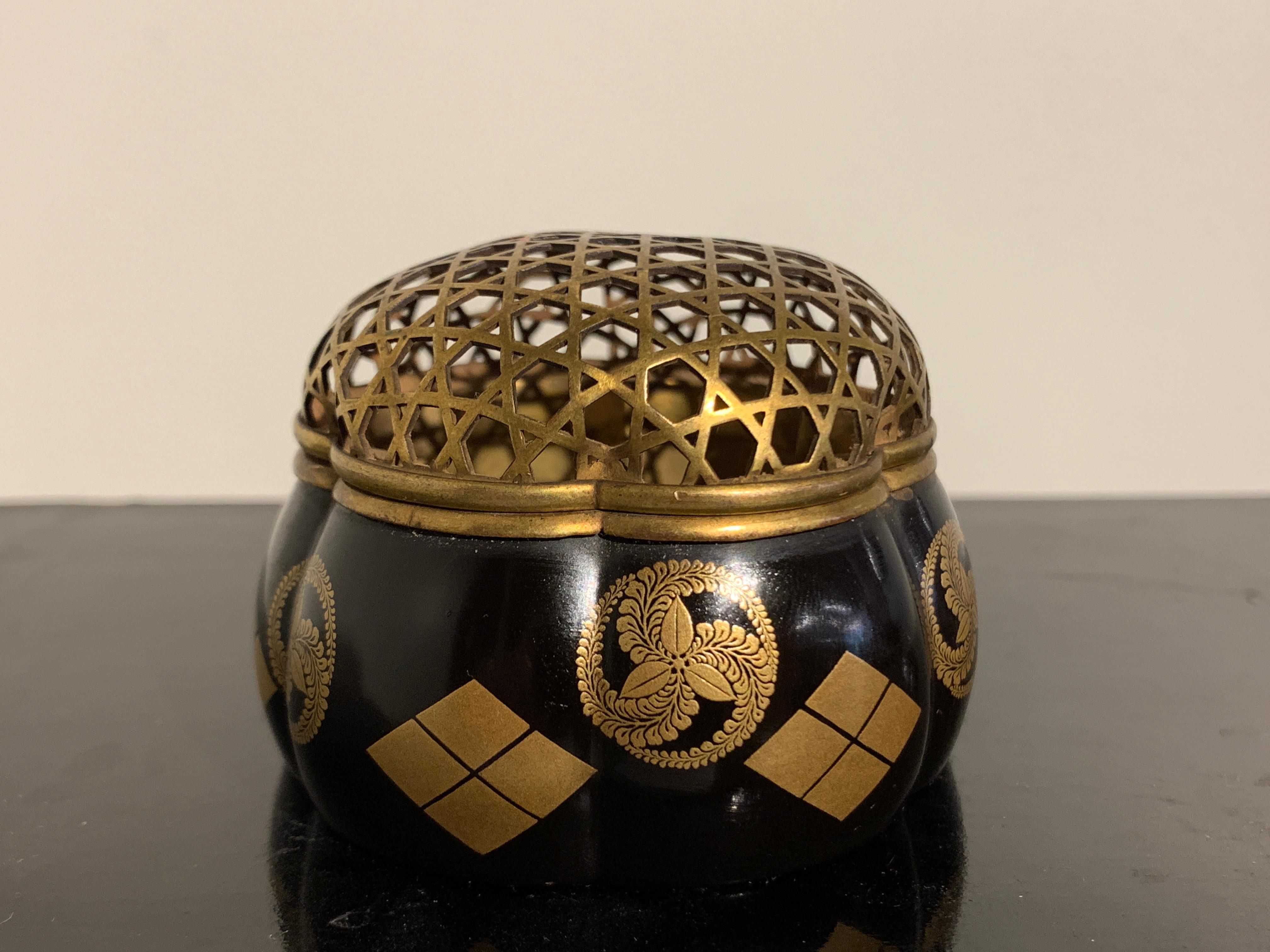 An exceptional Japanese black lacquer lobed incense burner, akoda koro, decorated with mon, Edo Period, 18th century, Japan.

The small censer of lobed melon form, called an akoda koro and decorated in a minimalistic fashion, with two graphic mon