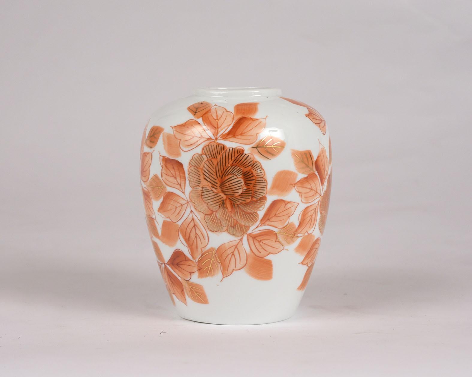 This beautiful 1950s Japanese Porcelain vase is in excellent condition and has its original glaze finish. The white vase has salmon-colored flowers and leaves pattern design with gilt accent details. This vase is in excellent condition and has no