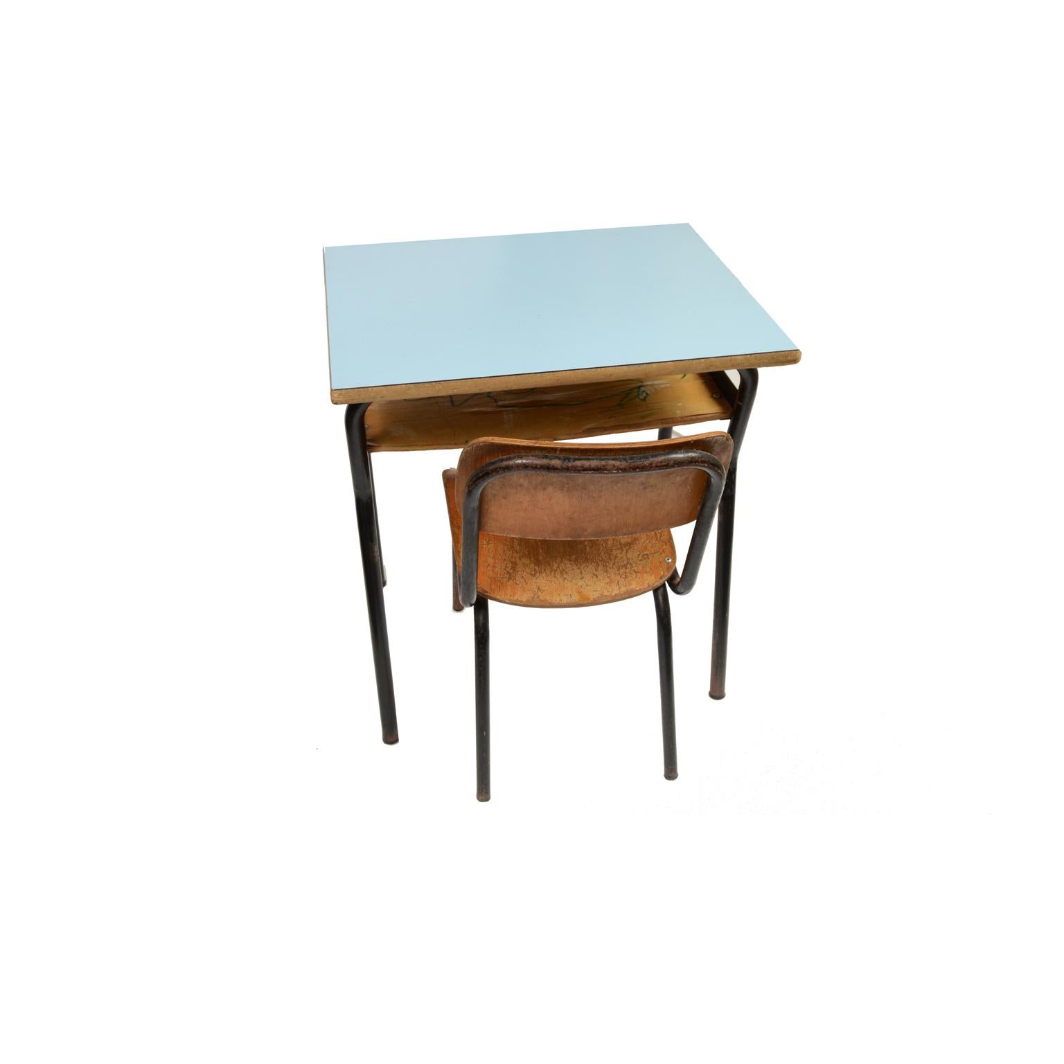 Small kindergarten desk made of wood with formica top and tubular structure of black painted metal, complete with small chair of wood and metal. 
Italian manufacture from the 1950s.
Good condition, signs of use. 
Desk cm 50 x 38 H 56.5. Chair cm 28