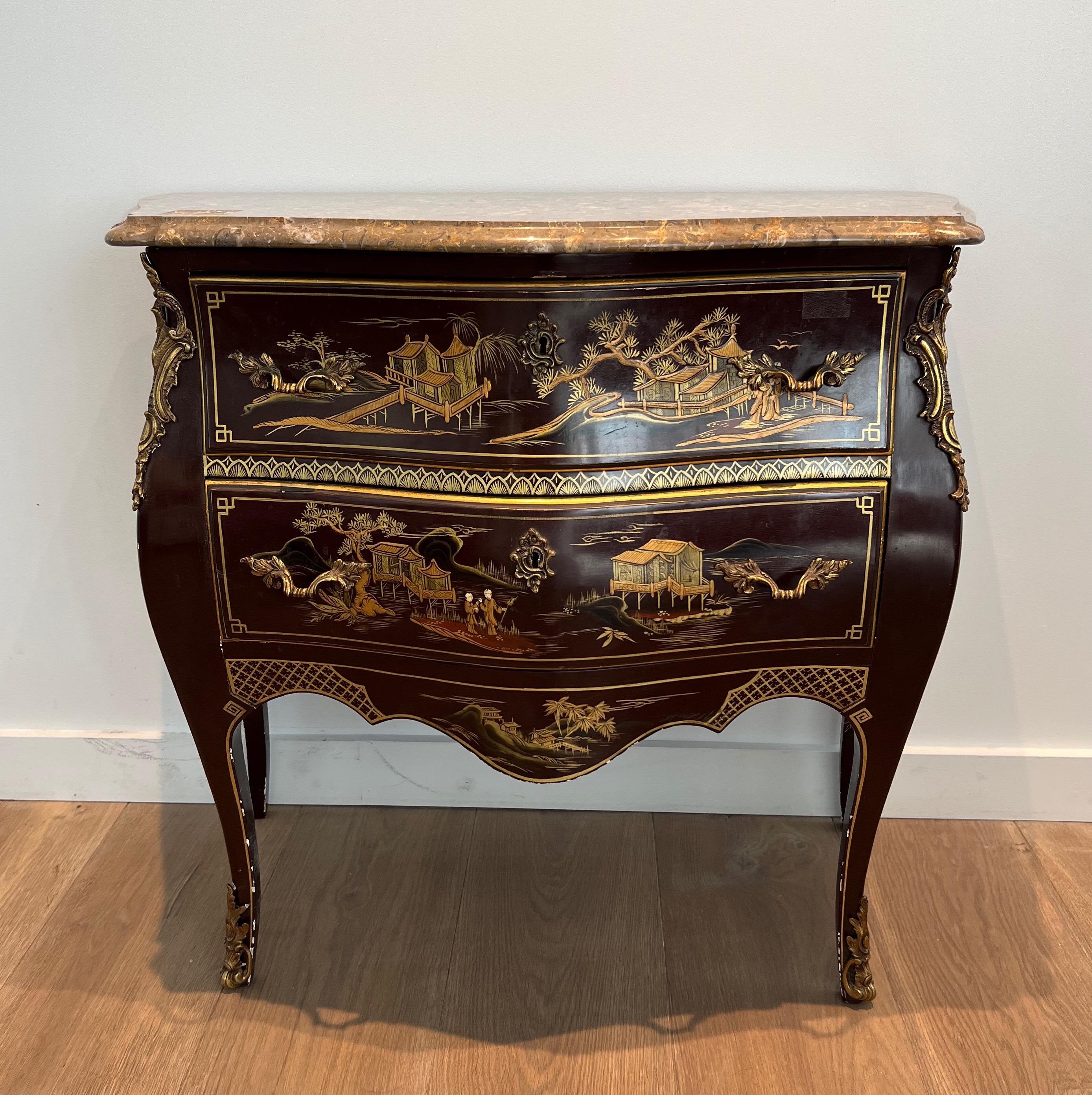 This very nice and decorative small commode is made of lacquered and gilt wood with chinese scenes. This very elegant chest of drawers is wonderfully decorated with bronze handles and feet. This is French work in the style of Maison Jansen. Circa