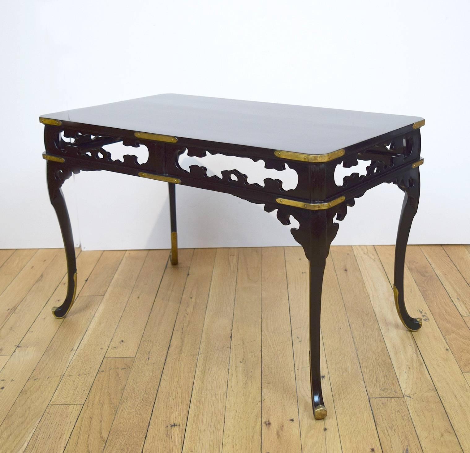 This exquisite, small, Japanese table was lacquered in a rich black, and mounted with gilt brasses. It probably dates to the early 20th century.
