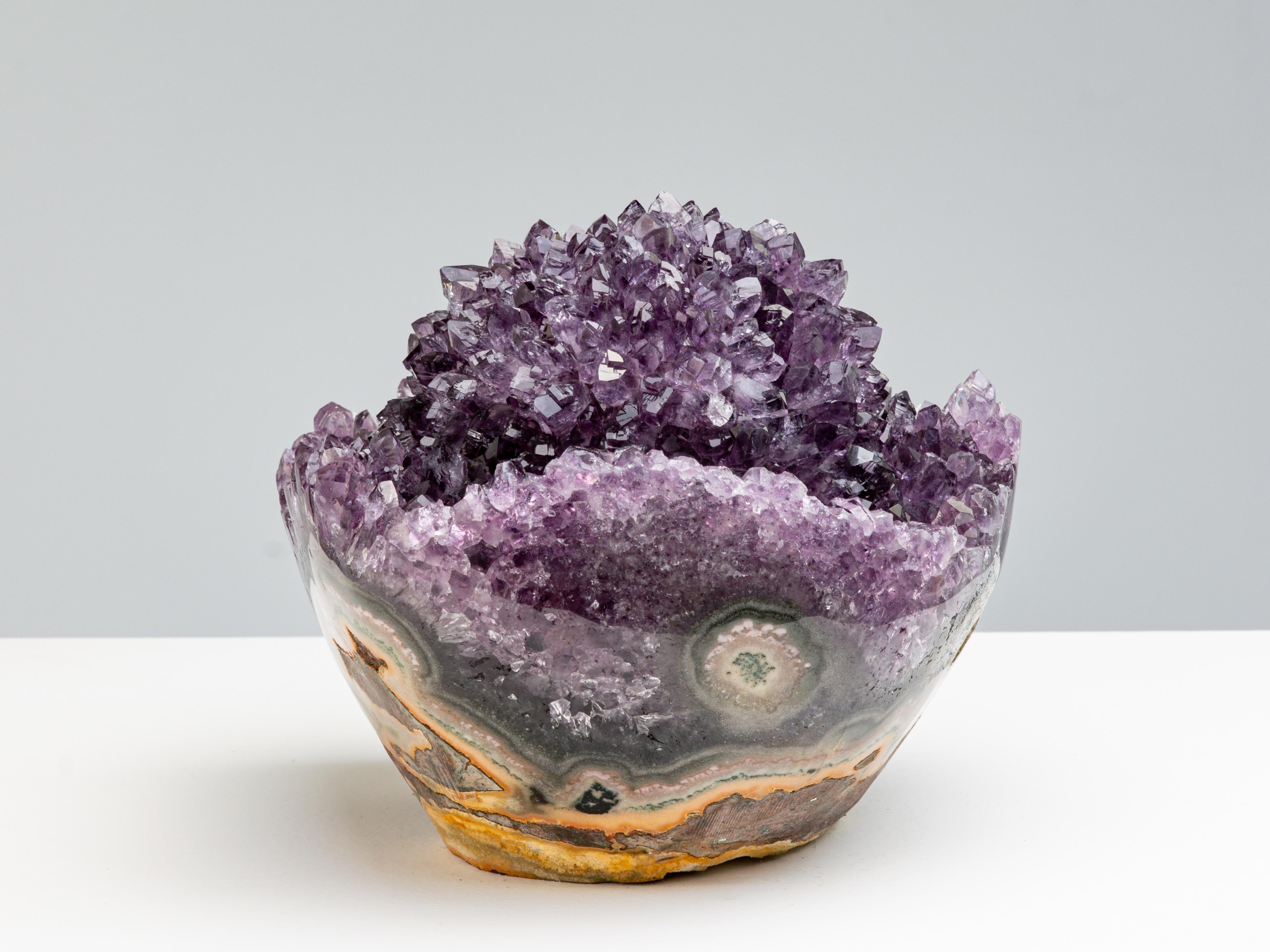 This modest sized formation has a beautful symmetry, with a rounded base and
a central stalactite with radially oriented amethyst crystals resembling a rosette.

This piece was legally and ethically sourced directly in the prestigious mines of
