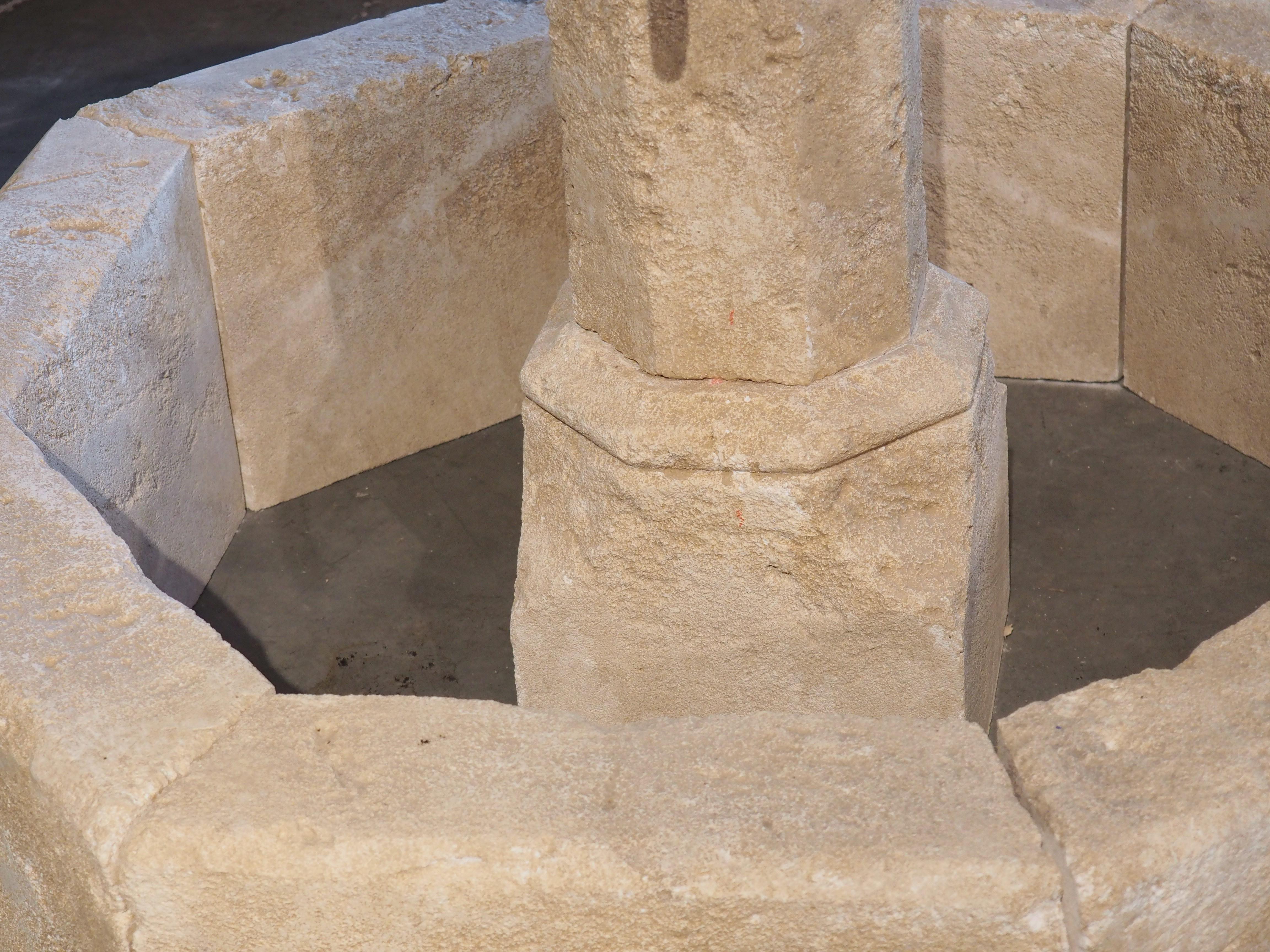 This wonderfully hand carved limestone, small centre fountain from France is octagonal in shape. It has four iron spouts that adorn the centre post. Always used as center fountains in villages throughout the ages in France, they are a beautiful