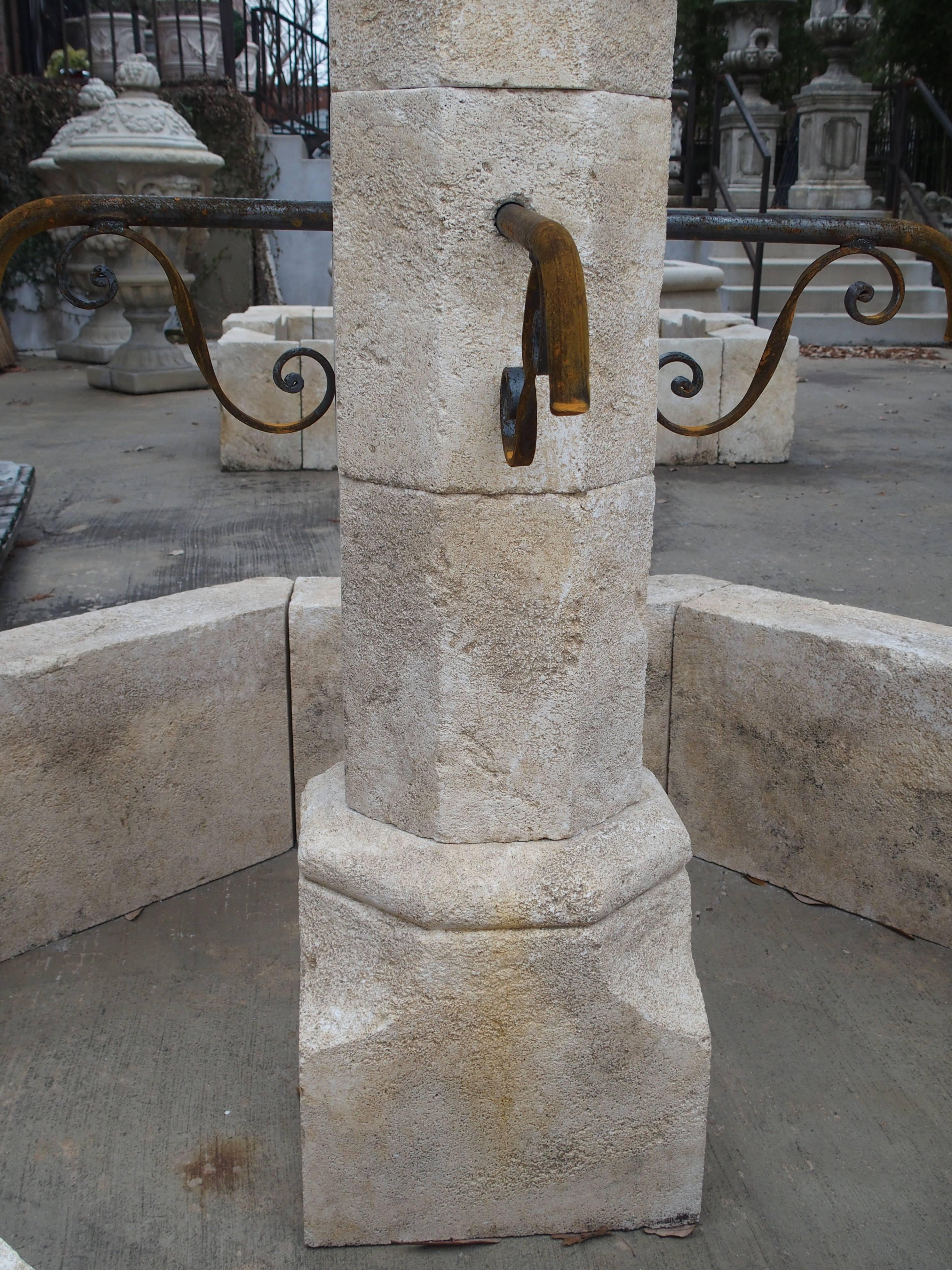 This wonderfully hand-carved limestone, small centre fountain from France is octagonal in shape. It has four iron spouts that adorn the centre post. Always used as center fountains in villages throughout the ages in France, they are a beautiful