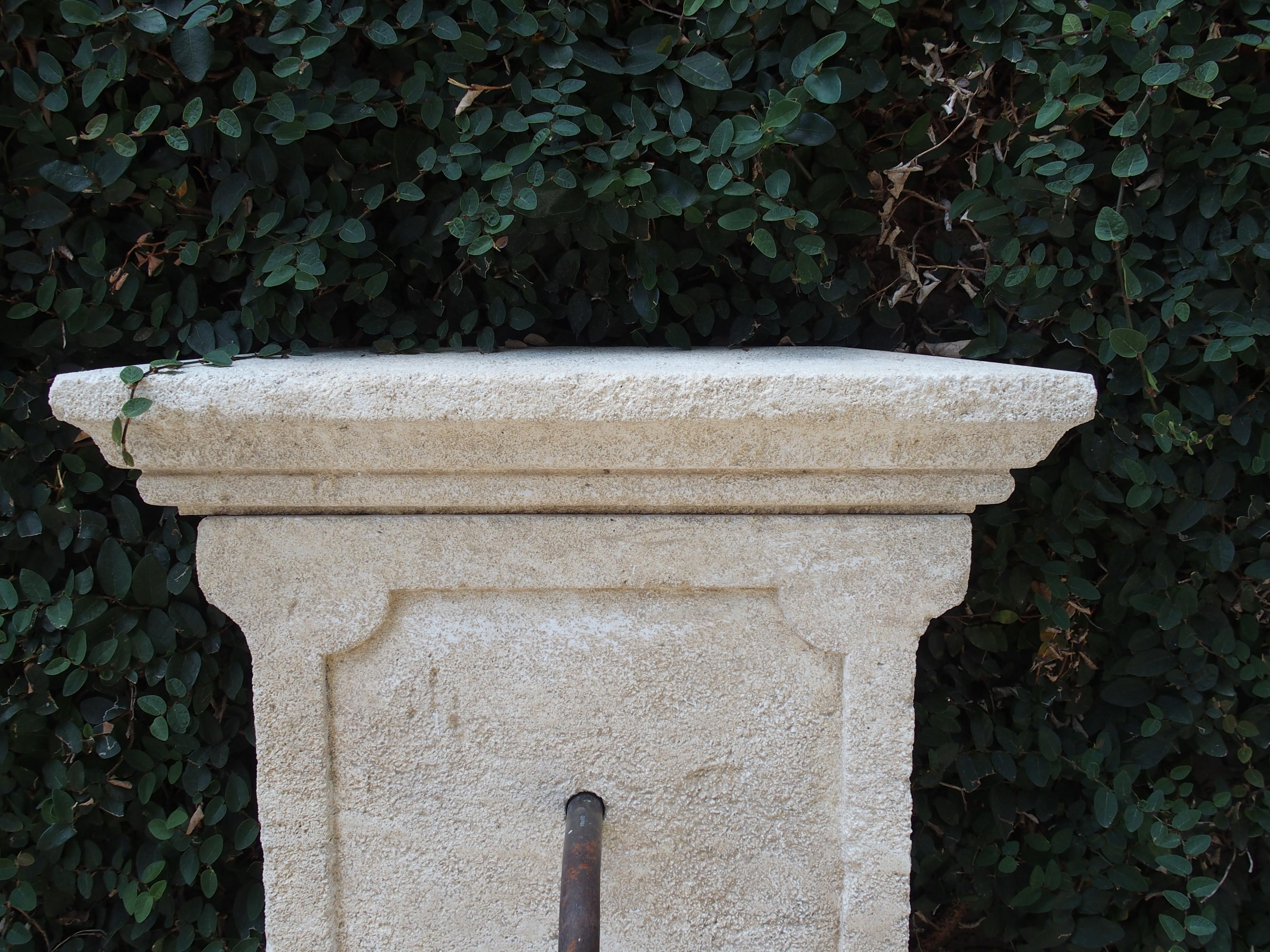 This small wall fountain has been hand-carved in Provence, France. It has an in-carved paneled back with shaped indents which is repeated on the front of the basin portion. The outside shape of the back also mirrors the design of the in- carving.