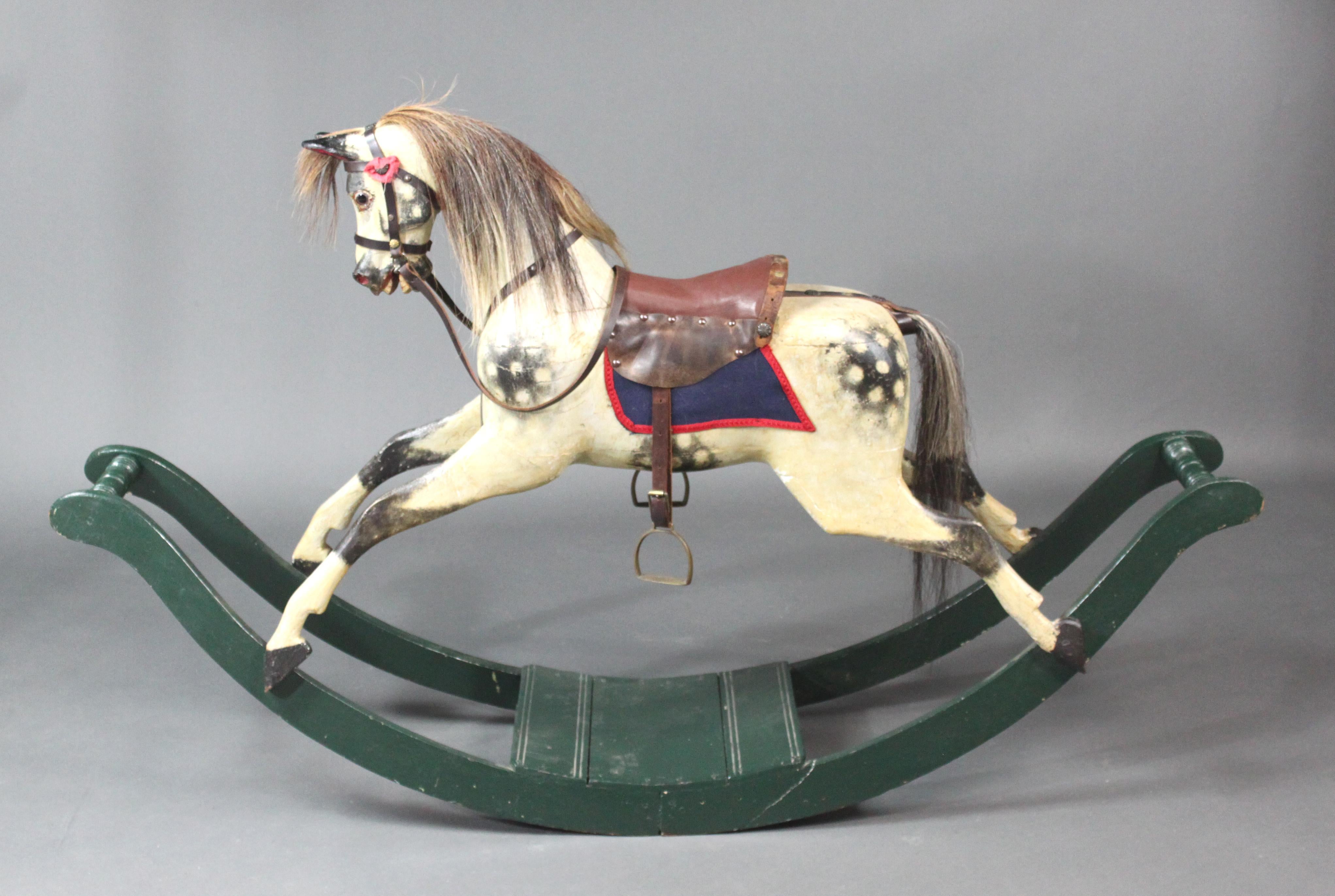 Small lines rocking horse on curved wooden rockers.
A small wooden rocking horse on curved rockers attributed to Lines Brothers; the original paint has been retained with a small amount of sensitive restoration; the mane and tail have been replaced