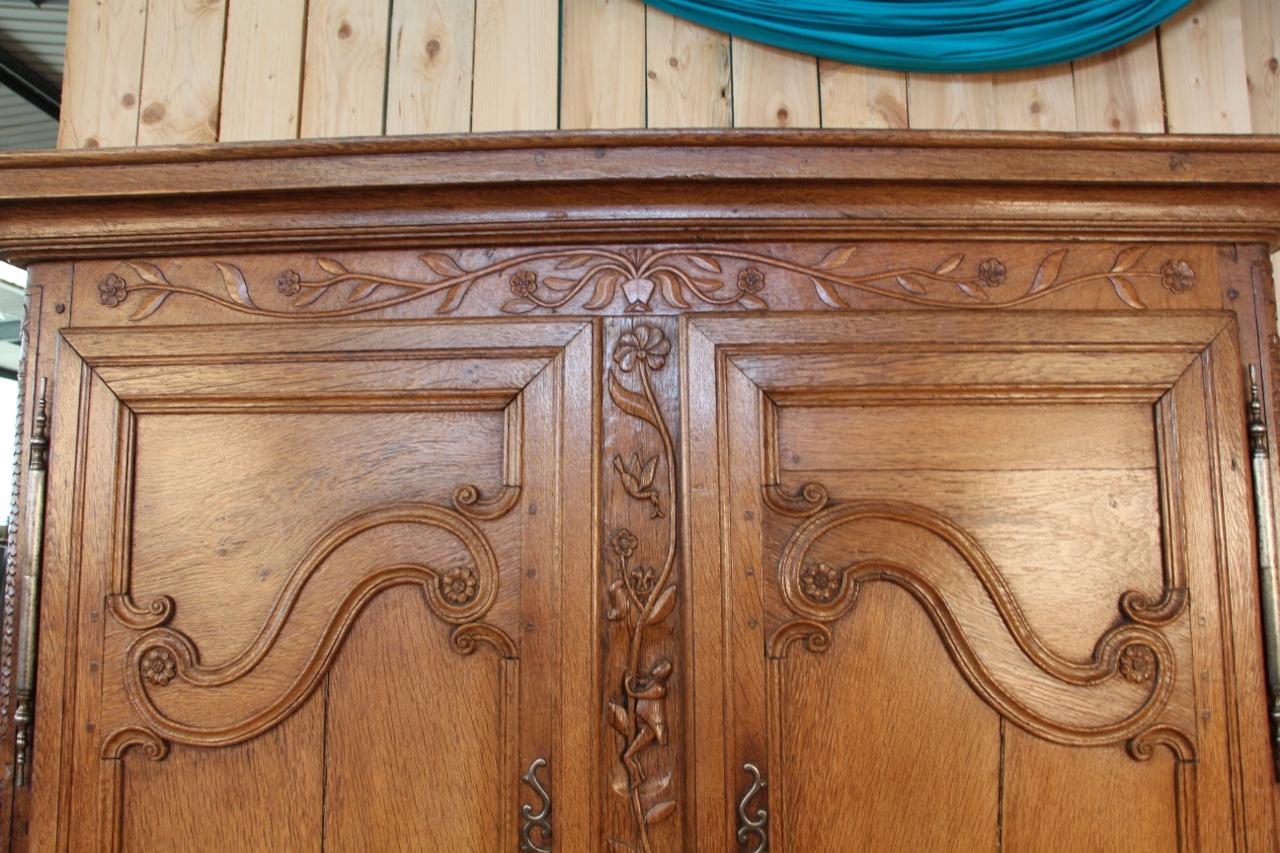 small Lorraine cabinet from the beginning of the 19th century in light oak with fine sculptures and the tree of life between its two doors Elm region and city two doors two drawers