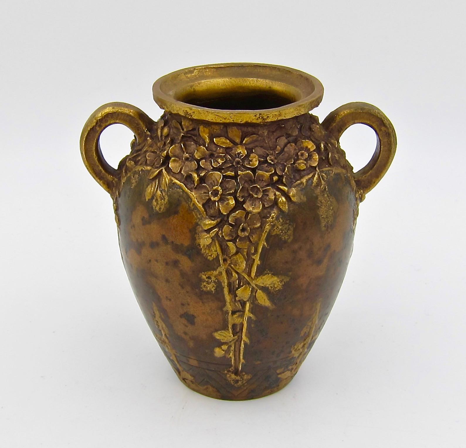 A diminutive antique gilt bronze vase from the Art Nouveau period stamped with the PARIS Louchet Ciseleur foundry mark, made in France circa 1900.

The heavy, double-handled vessel is decorated with gilt blossoms, stems, and leaves in relief. The