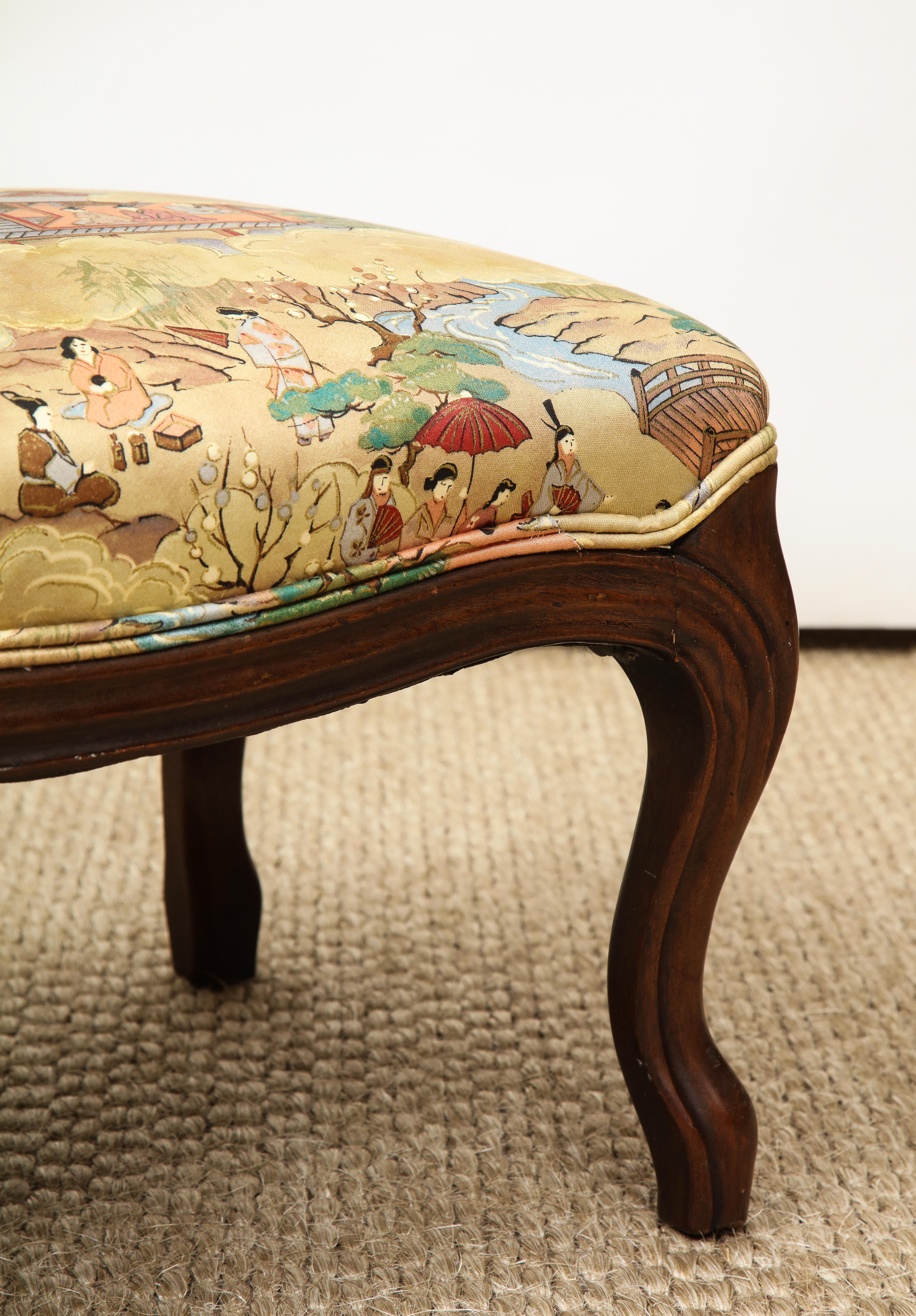 This Louis XV style footstool has cabriole legs and is upholstered in a chinoiserie motif silk. A perfect layering piece and a stylish place to perch your feet or some books!