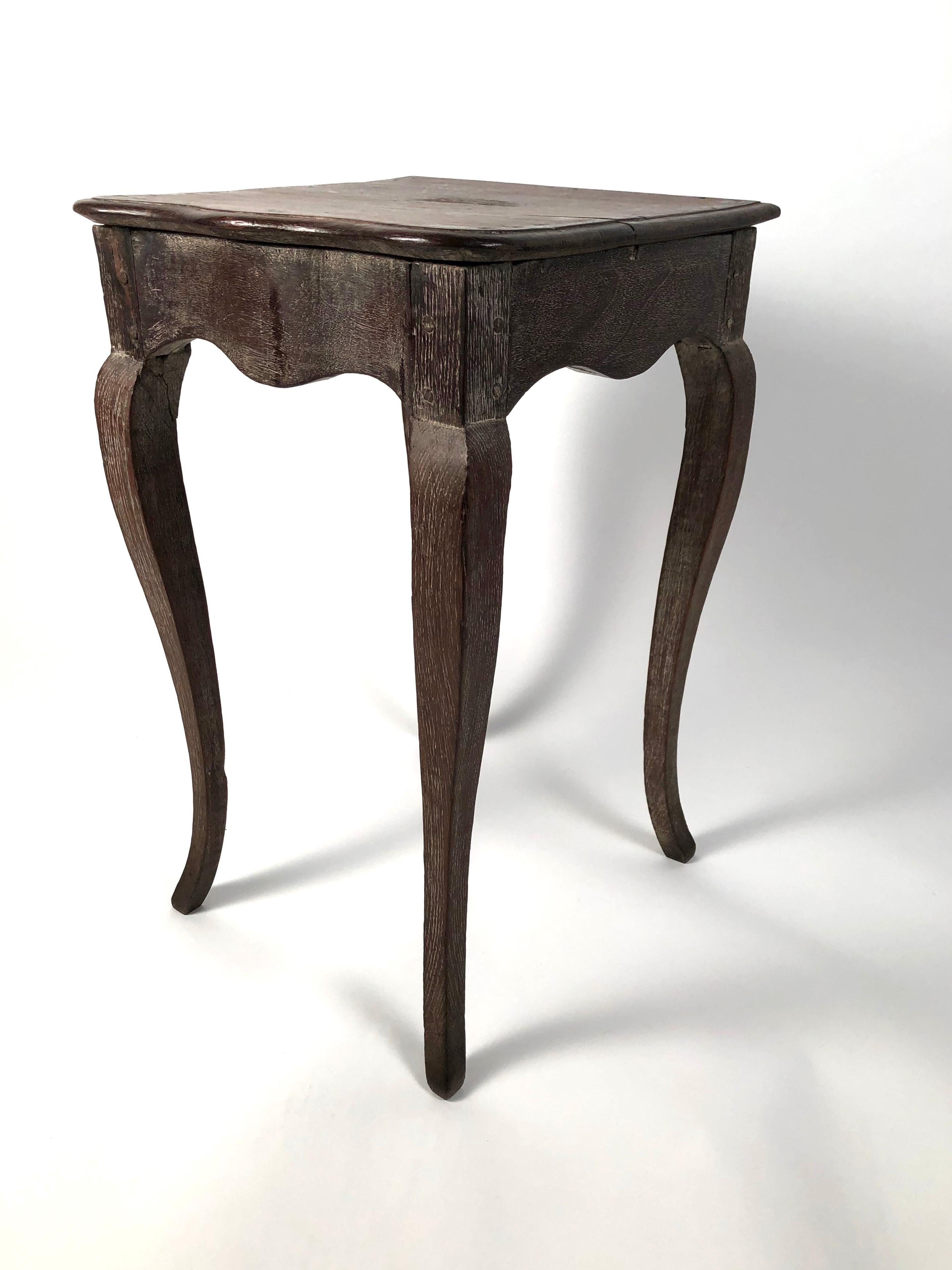 A small and stylish Louis XV style side table, the walnut nearly square top with molded serpentine edge in the front supported by 4 limed oak cabriole legs. Good patina and form. Perfect as a drinks table. Solid and very stable.