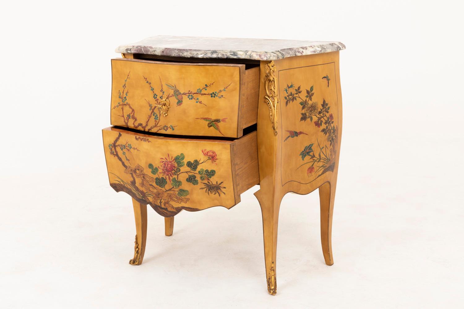 Small Louis XV style Chinese style yellow lacquered commode with a Chinese decor opening with two drawers sans traverse and standing on four console legs. Bulged shaped and scalloped lower crossbar.
In front and framed on side, ornaments on a