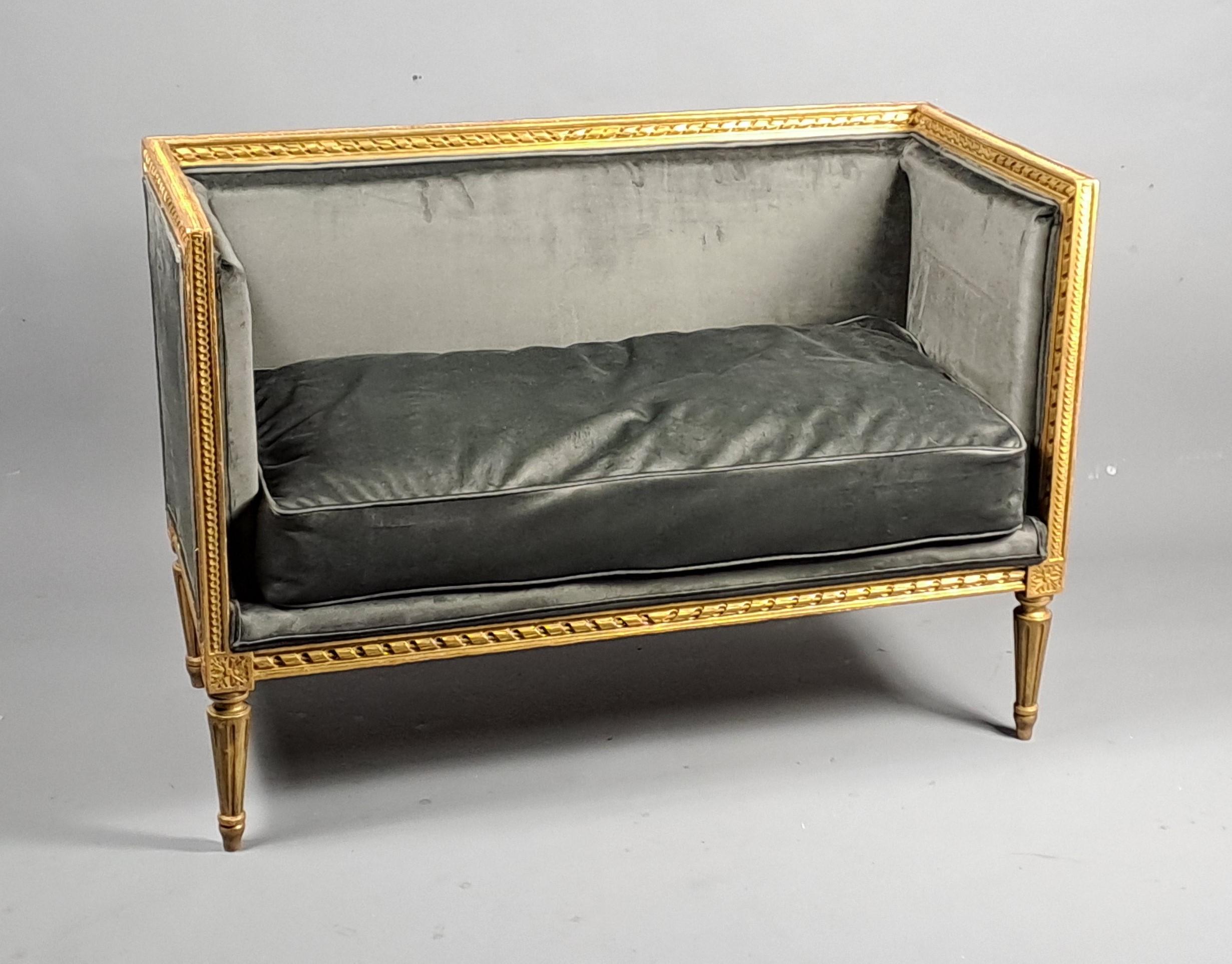 Lovely little Louis XVI style rectangular bench in gilt wood finely carved with interlacing friezes and ribbon stick, resting on four tapered fluted legs.  Beautiful taupe satin velvet upholstery, feather cushion with piping.  French work from the