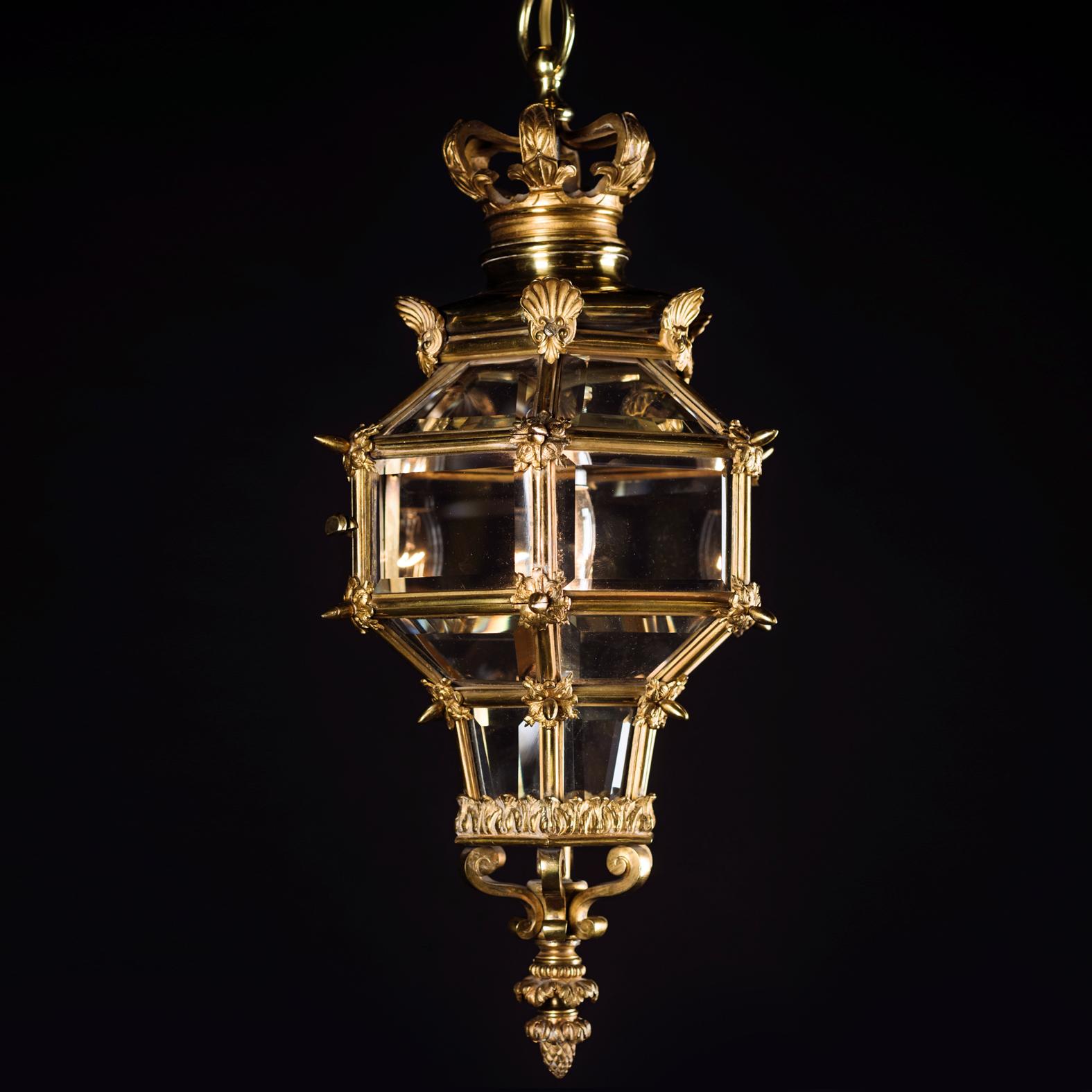 A small Louis XVI style gilt bronze lantern modelled after the Versailles Model.

Of hexagonal form surmounted by a corona cast with fleur-de-lys and scallop shells. 

French, circa 1900.
