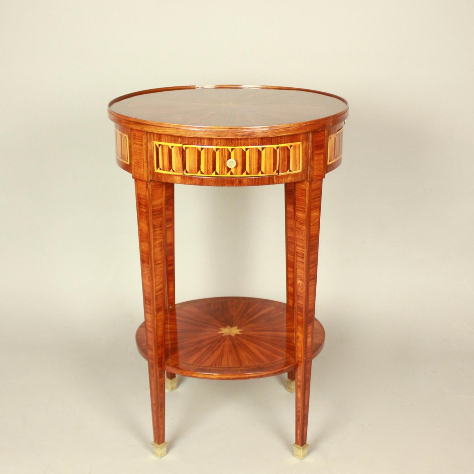Small French 19th Century Louis XVI Style Marquetry Side Table or Gueridon

A small Louis XVI style marquetry side table or gueridon with a marquetry top featuring a central star, the frieze section with one drawer and one small candle slide, the