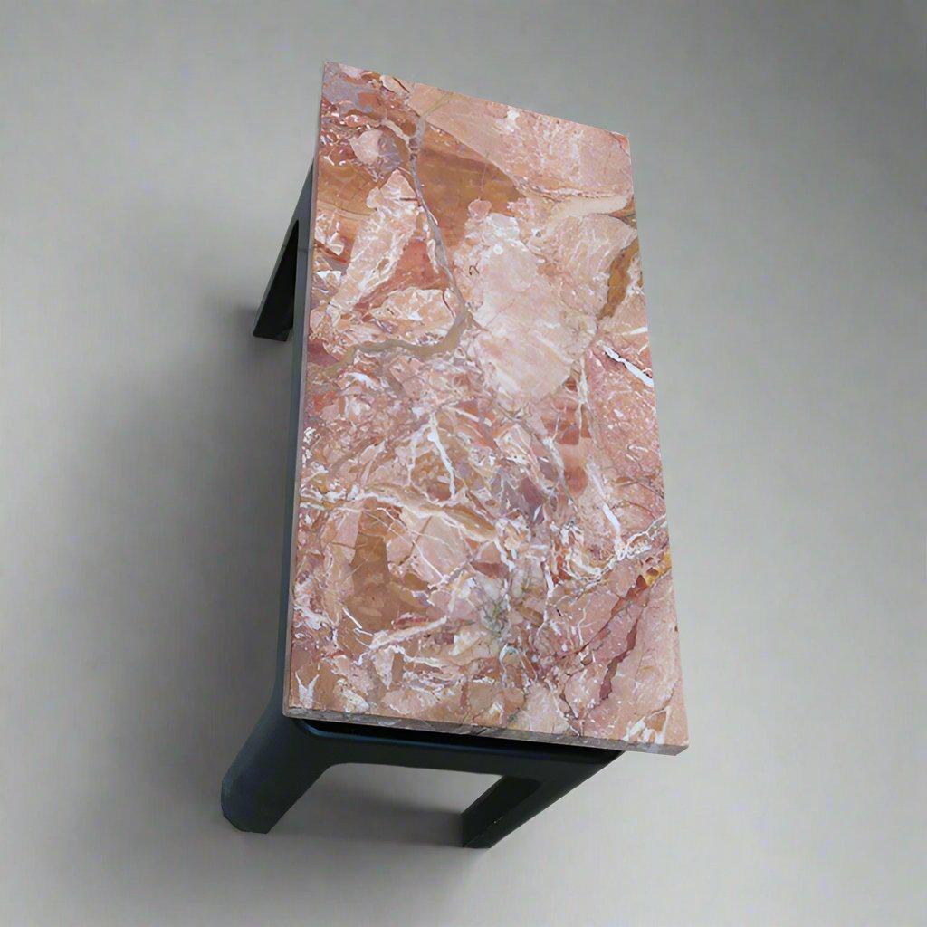 A small low side table attributed to Eleanor Le Maire. 
Marble top with an ebonized wood base.
