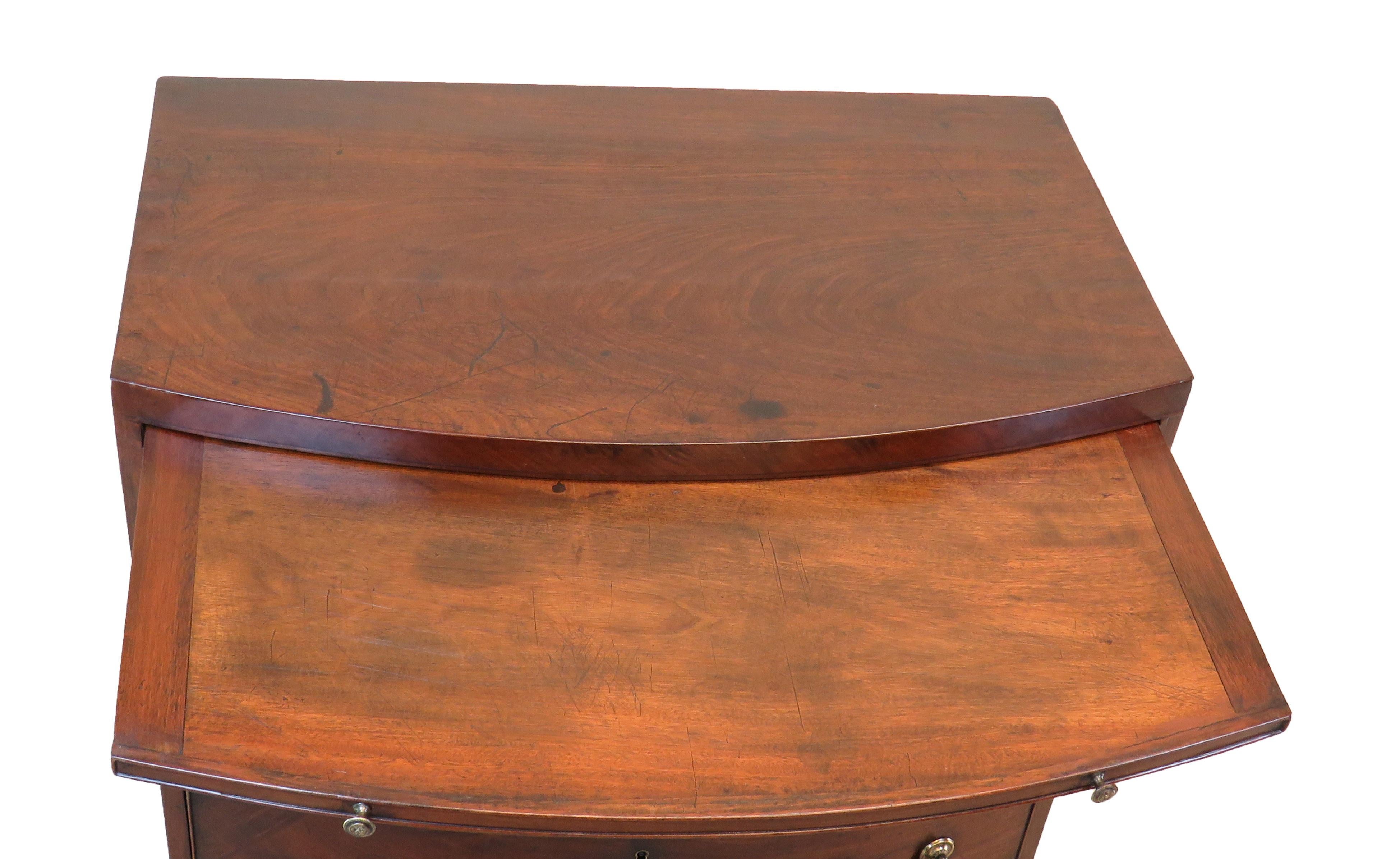 A superb quality 18th century mahogany bowfront
Chest of unusually small proportion having well
Figured top above slide and three long drawers
Retaining original brass swan neck handles raised
On original splay bracket feet

(An incredibly