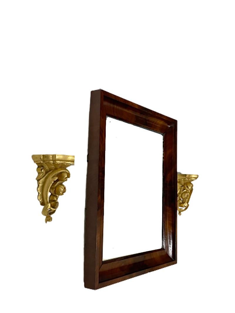 Small mahogany mirror with gilt wood rocaille scroll wall brackets

Small mirror with 2 miniature wall brackets in carved gilt wood with rocaille scrolls
Mirror in mahogany wooden frame (tiny chip) 
The small wall brackets with rocaille scrolls