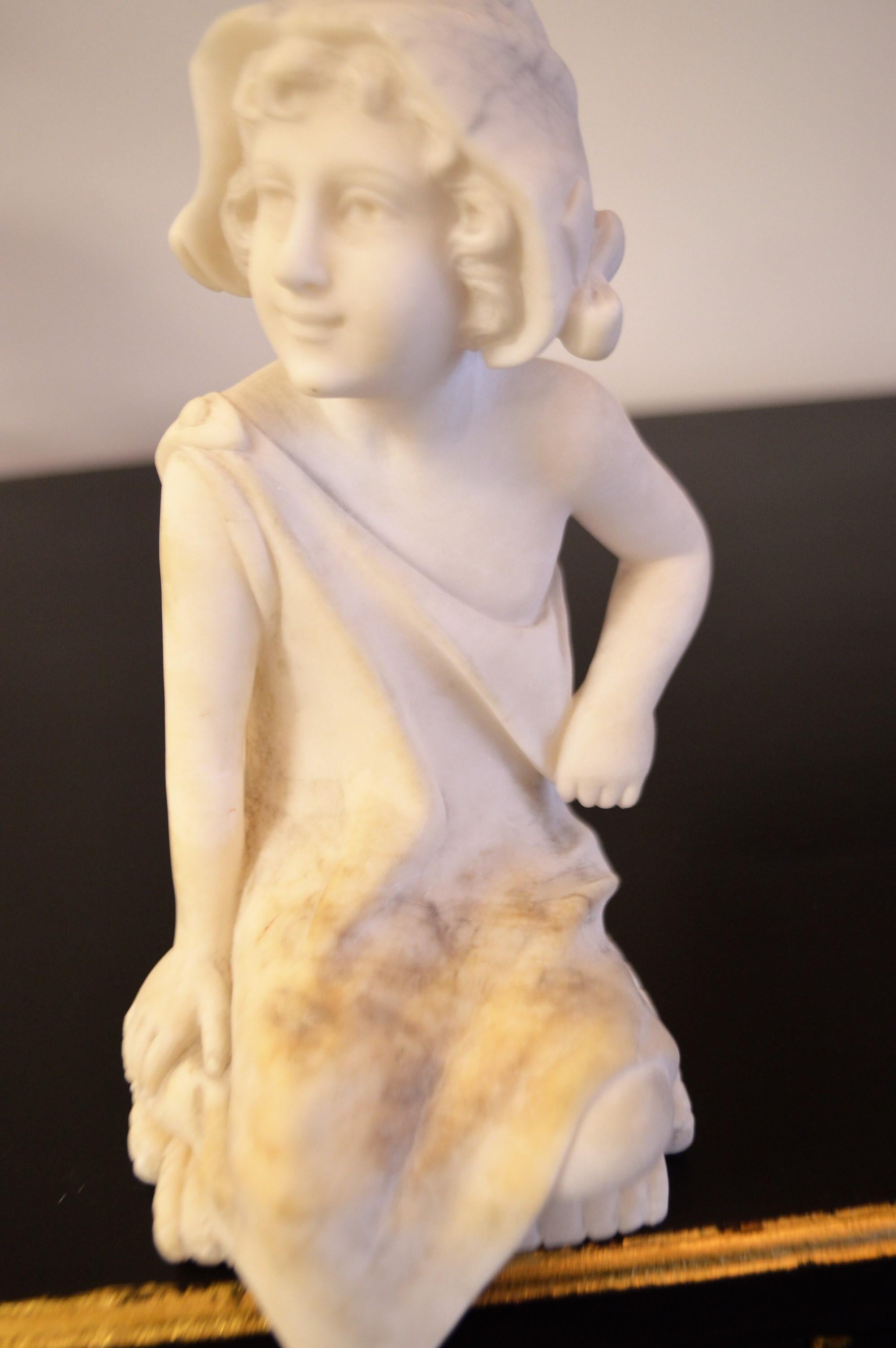 Unusual small charming marble of a pretty young girl wearing a hat and in a sitting position. The marble piece is made to sit on an edge wherever your imagination takes you.
The marble is a creamy white shows some age and is in 
excellent
