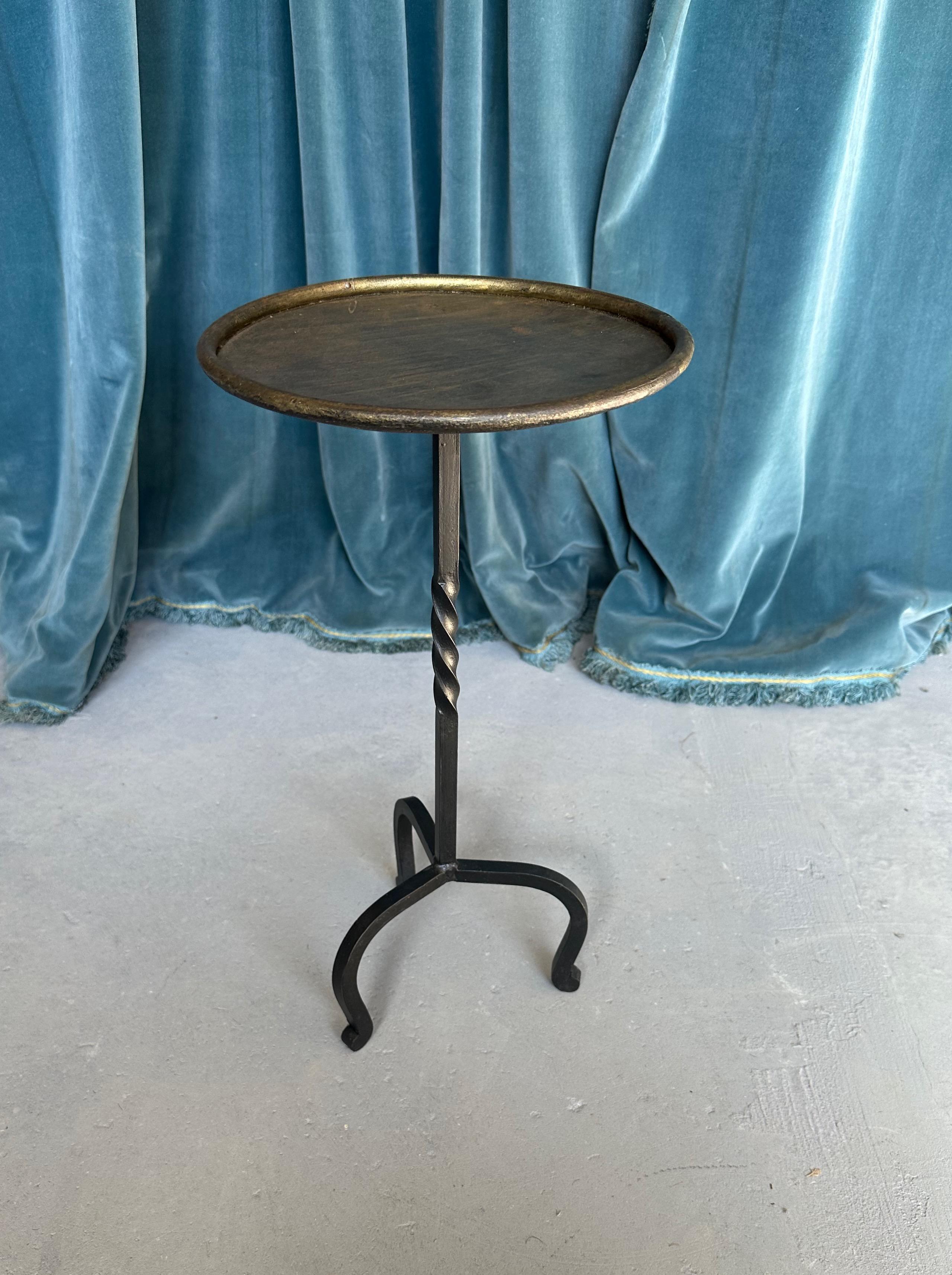 This striking Spanish drinks table was recently created by accomplished artisans using traditional iron-working methods with an emphasis on superior quality. Based on a 1950s design, the table boasts a captivating fusion of contrasting elements,