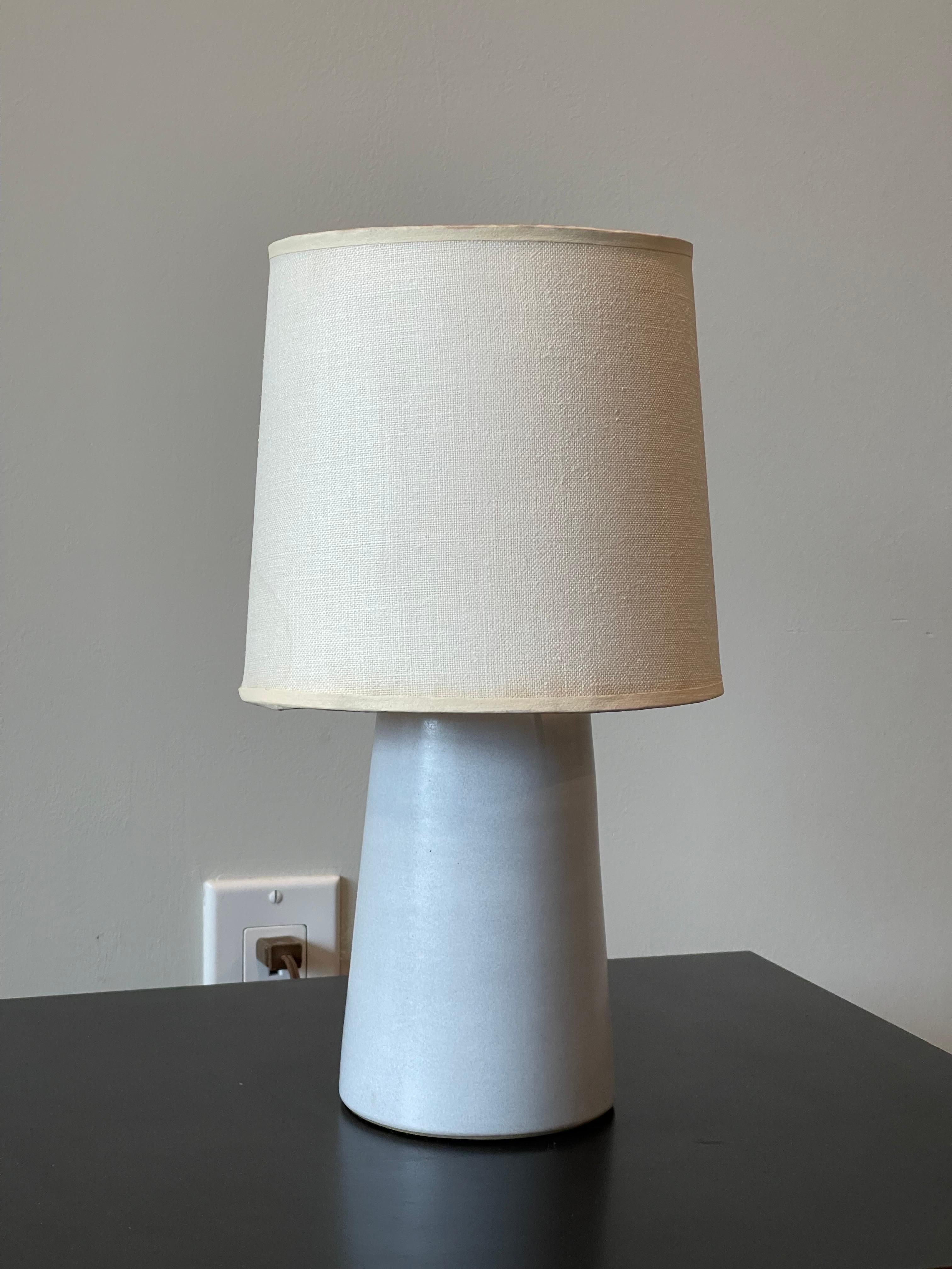 Excellent early, and rare form diminutive stoneware bookshelf or desk lamp by Jane & Gordon Martz for Marshall Studios. Diminutive light holds a normal based bulb. Original shade isn't perfect; it was glued on the seam in the back and slight dried