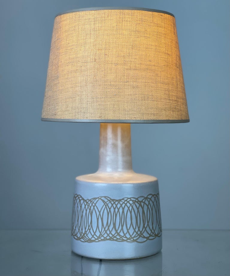 Small stoneware lamp with the desirable incised sgraffito etchings/patterns by iconic lighting designers Jane & Gordon Martz for Marshall Studios. No chips or any issues. It has been rewired. Shade is not included. 
Two types of shades were used -