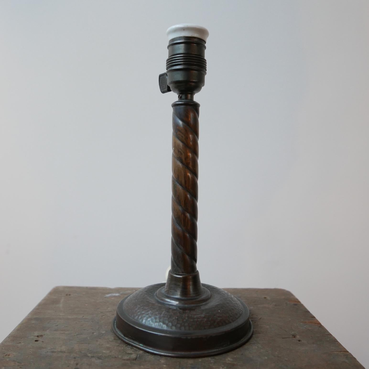 An antique small table lamp. 

Sweden, c1930s. 

Patinated and hand beaten metal likely brass or copper. 

Since re-wired and PAT tested. 

Some scuffs and wear commensurate with age, some small dings, but generally good condition.