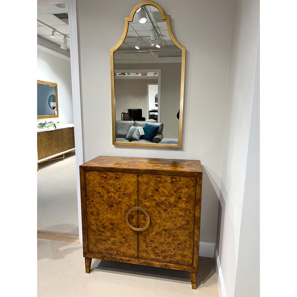Small midcentury Burl Cabinet with a warm 'rustic' hand-rubbed mappa burl veneer, a beveled frame, two doors with a polished brass central round handle, two internal shelves, and raised on square tapered and flared legs.

Dimensions: 36