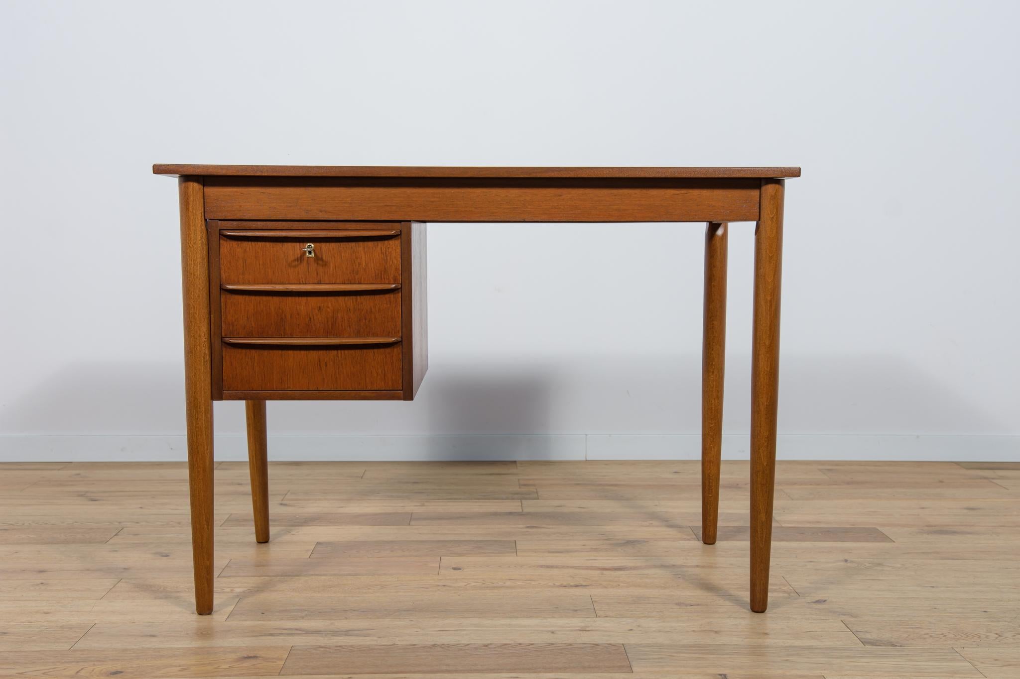 
A small desk made in the 1960s in Denmark. It has a module with three drawers with contoured handles. The desk has been professionally renovated and is made of teak wood. It has been cleaned of the old coating, painted with an oak-colored stain and