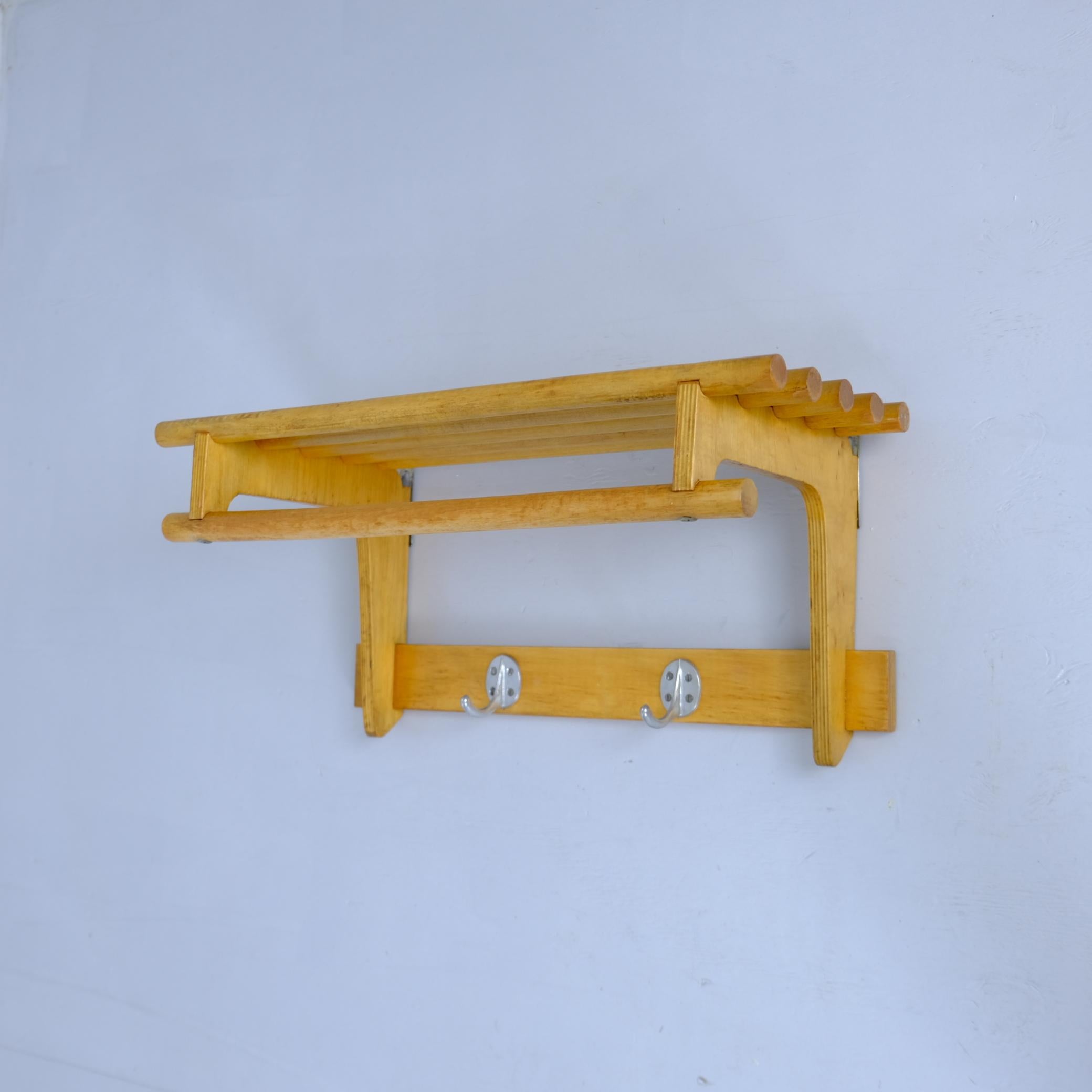 Un charmant porte-manteau et porte-chapeau moderne du milieu du siècle en bouleau massif, complété par deux crochets métalliques d'origine. Son design incarne l'essence du fonctionnalisme scandinave et finlandais : simple, chaleureux et bien pensé.