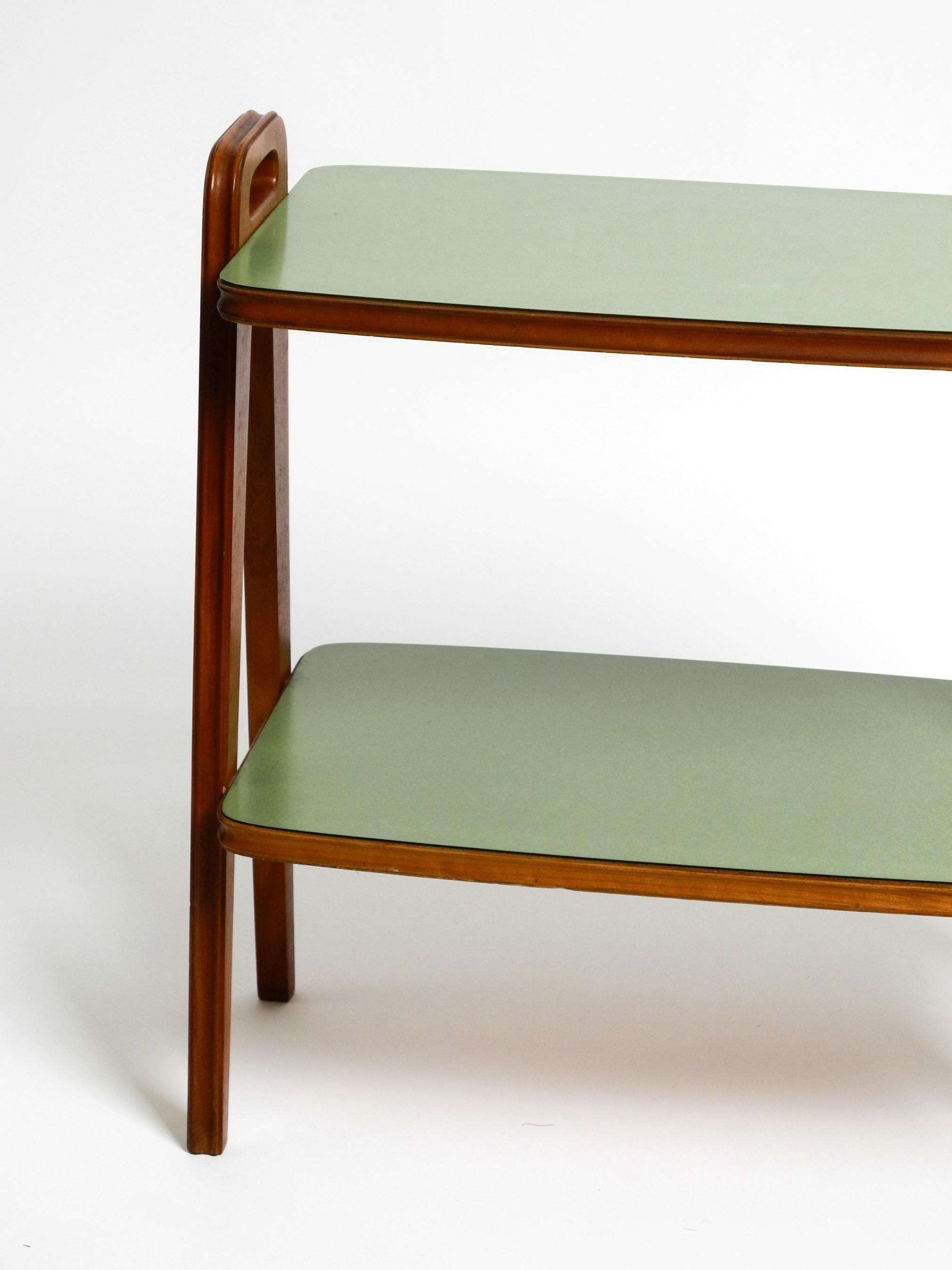 Small Mid Century Modern side table made of walnut with green Formica surfaces 6