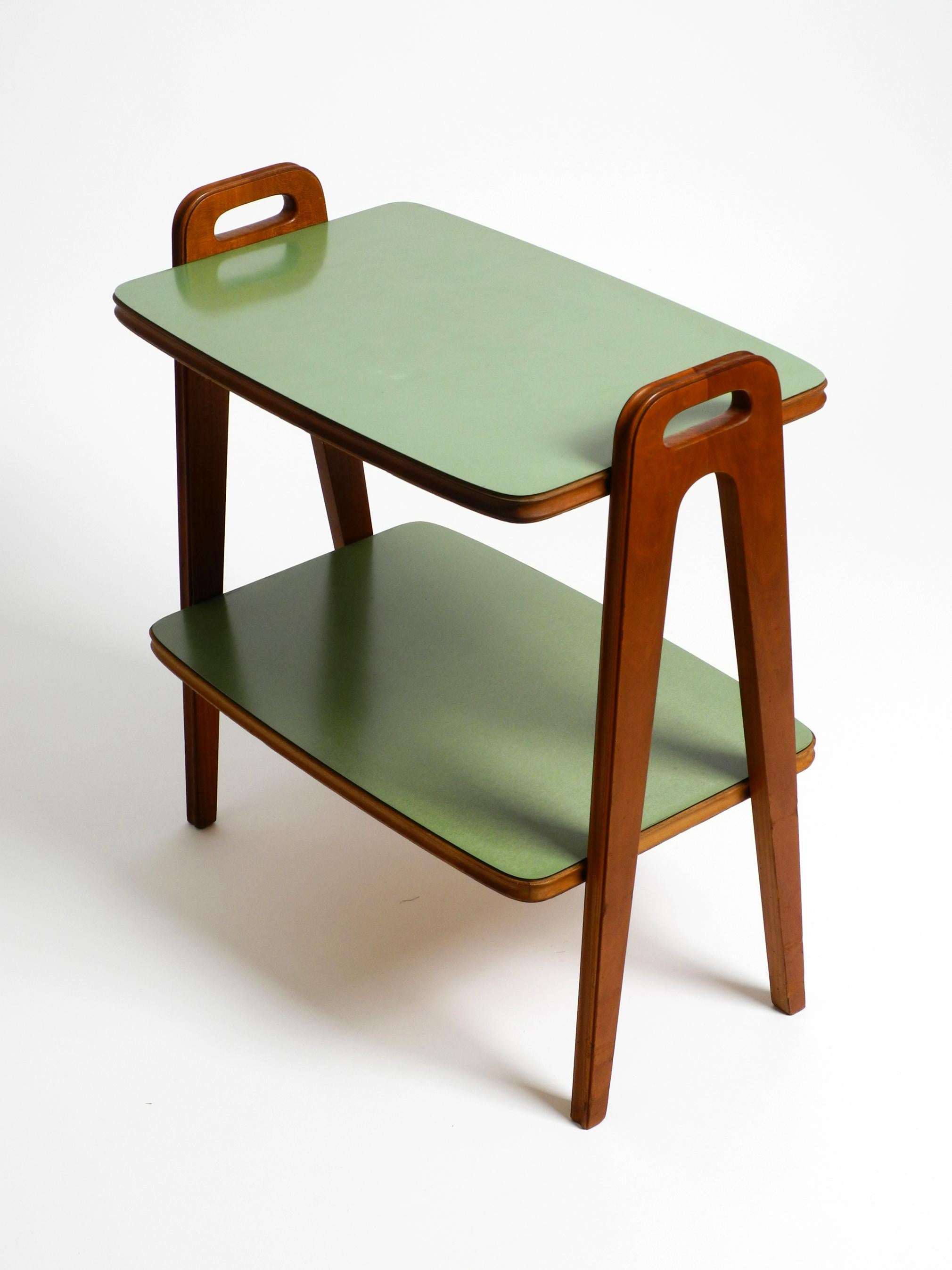 Small Mid Century Modern side table made of walnut with green Formica surfaces 8