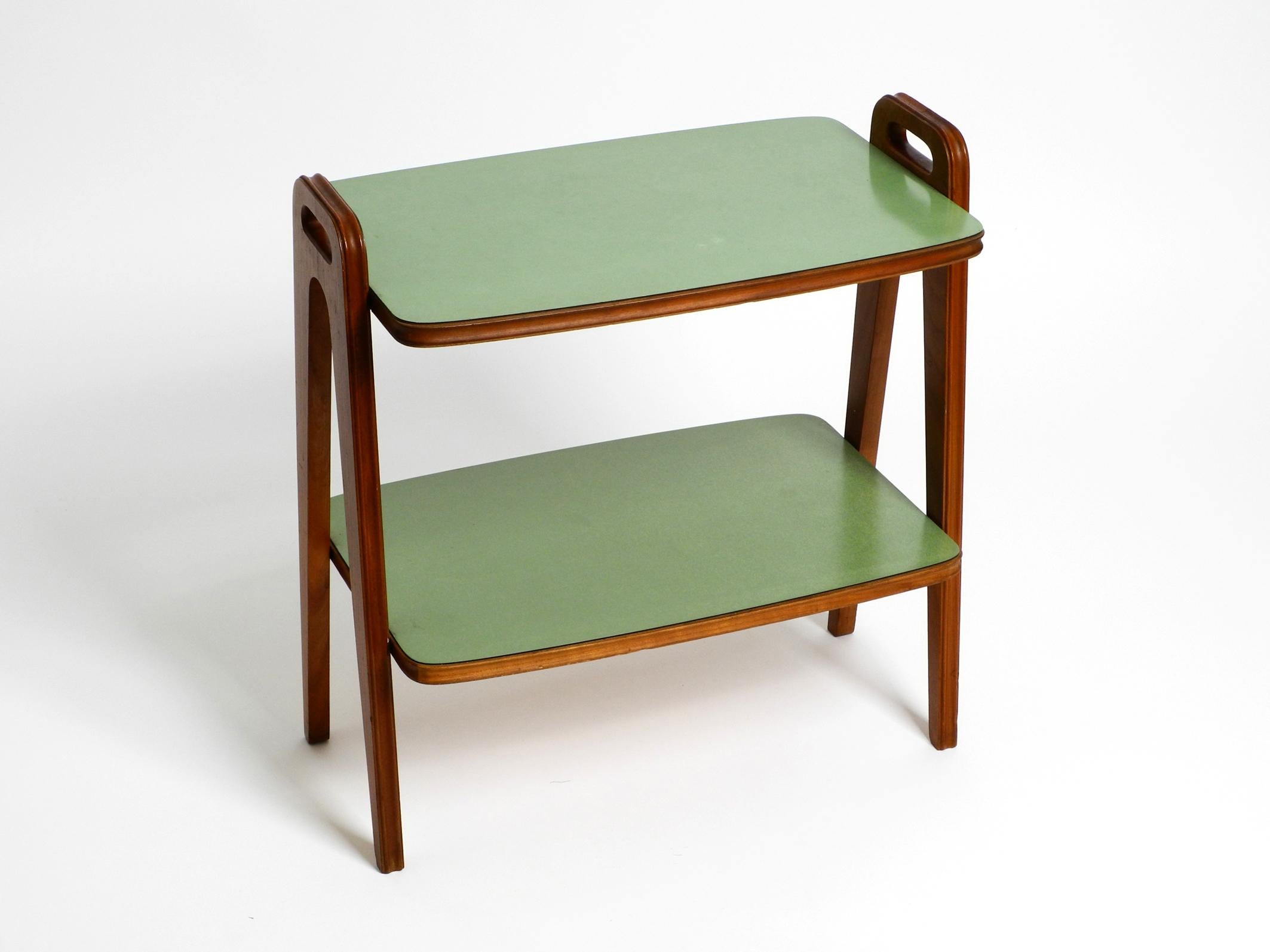 Small Mid Century Modern side table made of walnut with green Formica surfaces 12